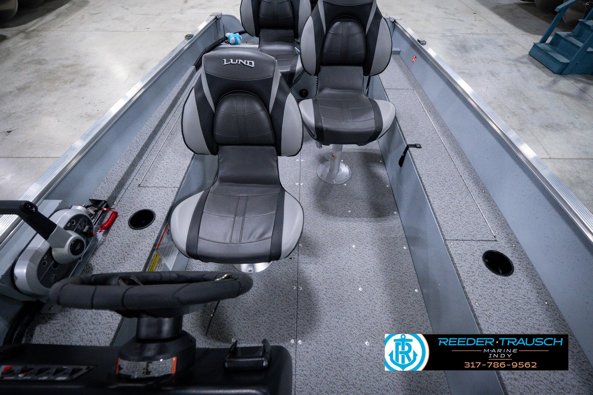 2026 Lund 1600 Fury SS boat interior with gray seating and steering console.