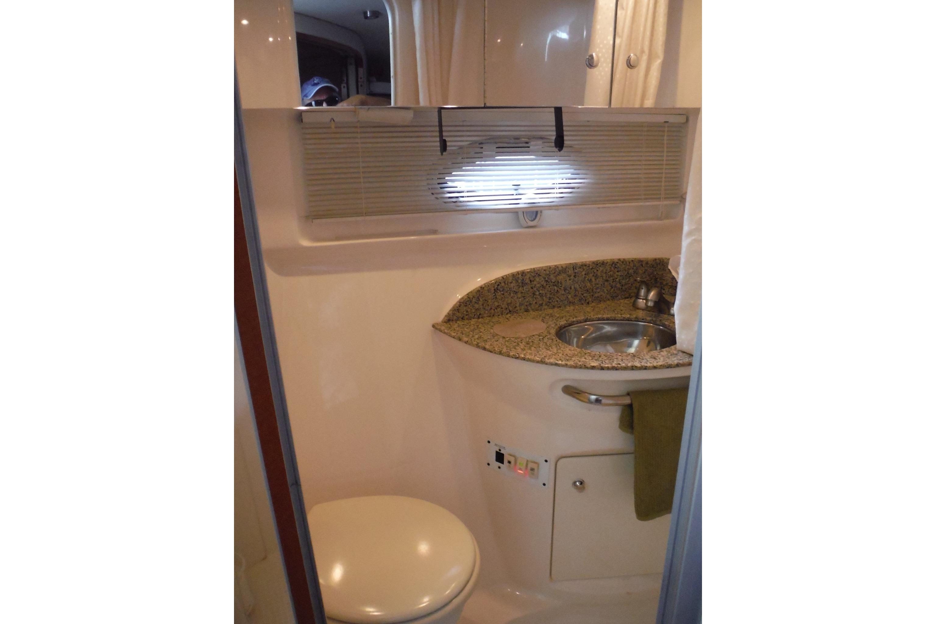 2005 Chaparral Signature 350 boat bathroom with sink, toilet, and granite countertop.