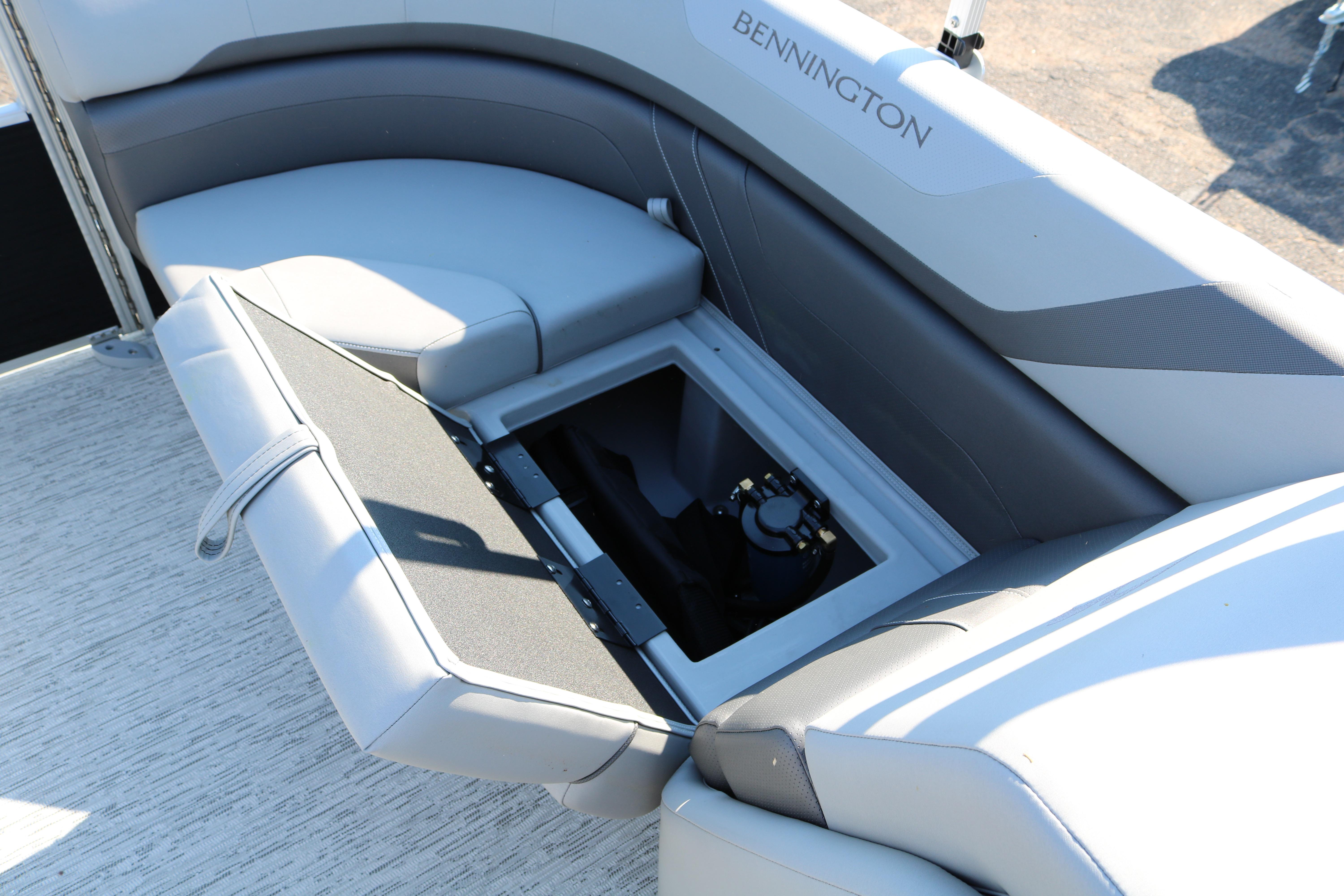 2026 Bennington 22SX Stern Radius boat with open storage compartment.