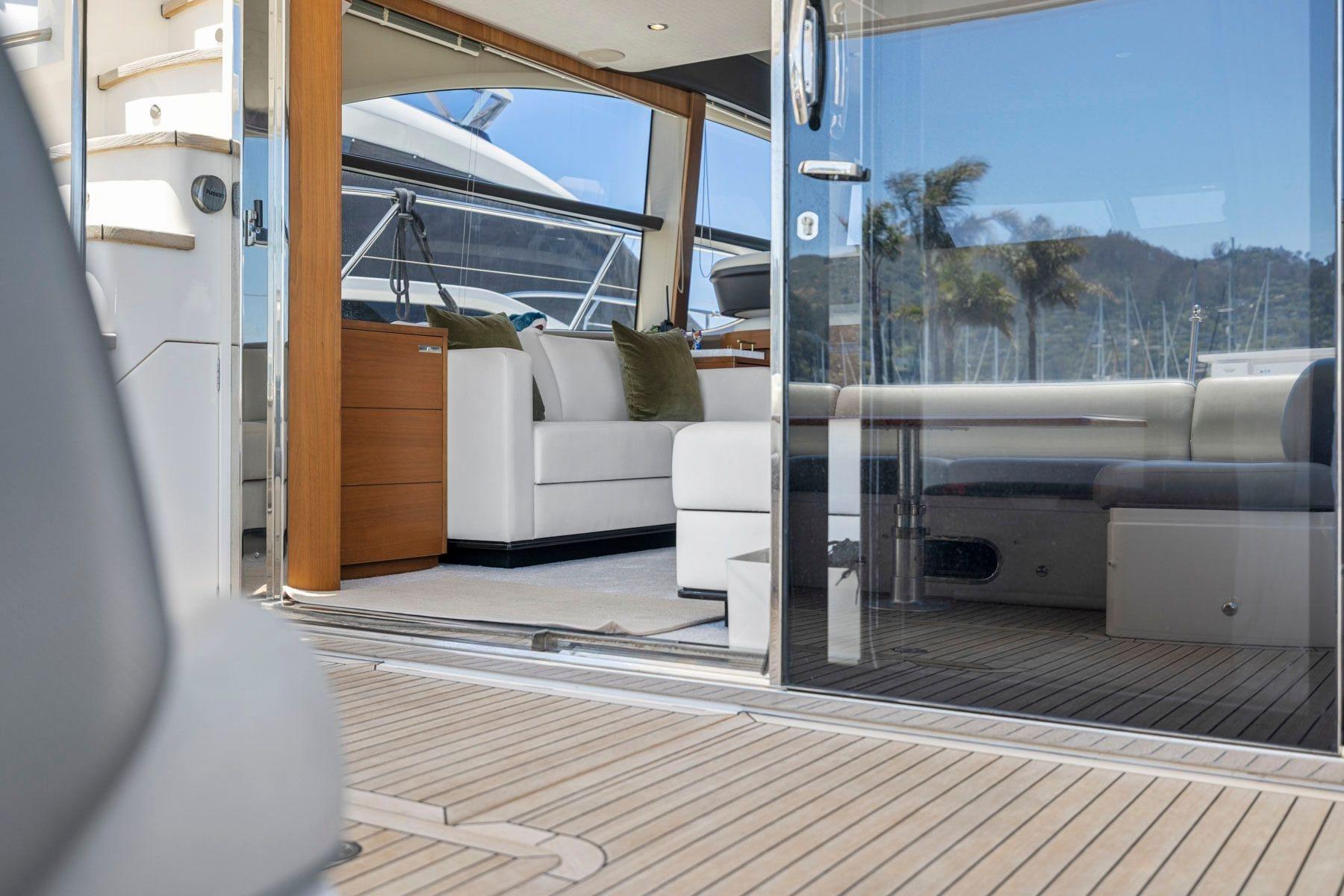 Luxurious interior of a 2015 Princess 60 Flybridge Motor Yacht with elegant seating and wood accents.