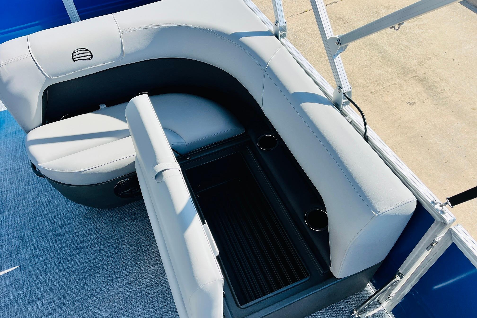 2026 Sun Tracker Party Barge 18 DLX seating area with cup holders and storage.