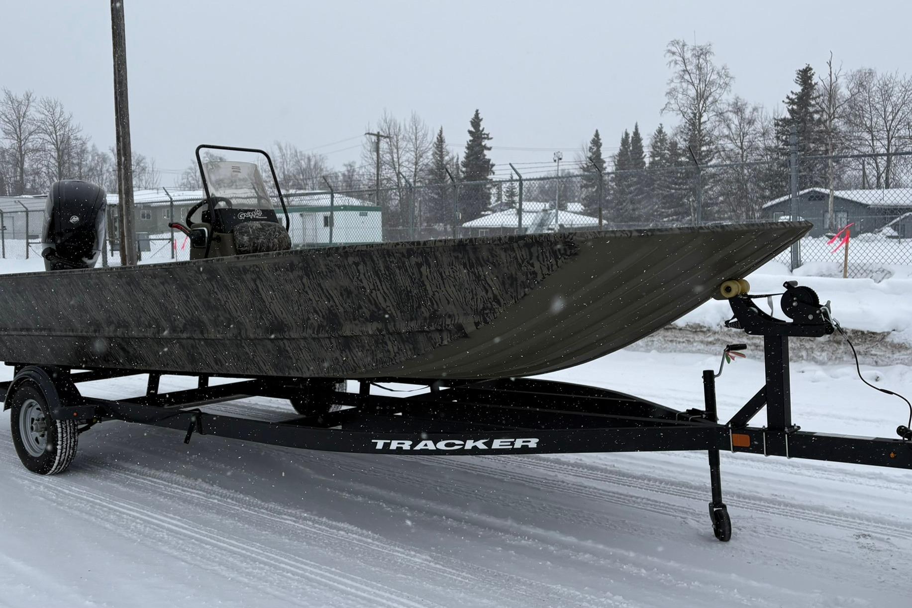 2025 Tracker Grizzly 2072 CC boat on trailer in snowy setting.
