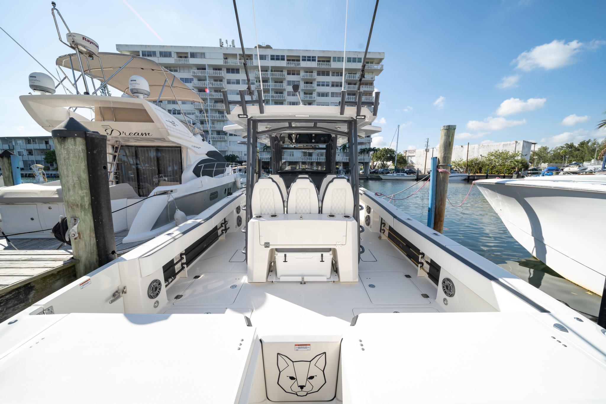 2022 World Cat 400 CC-X boat docked at marina, clear sky background.