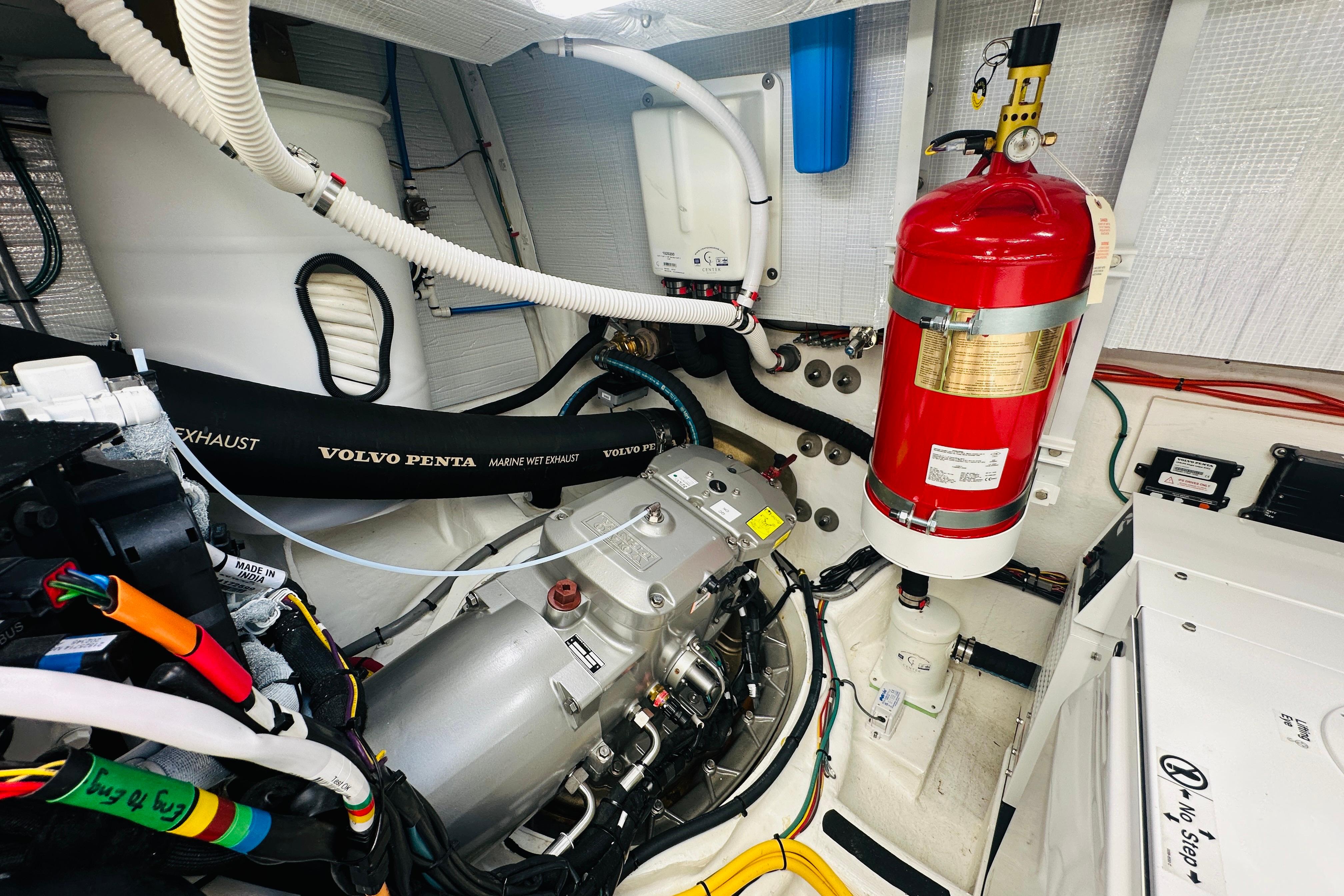 Engine room of 2025 Sabre 48 Salon Express with Volvo Penta components and fire extinguisher.