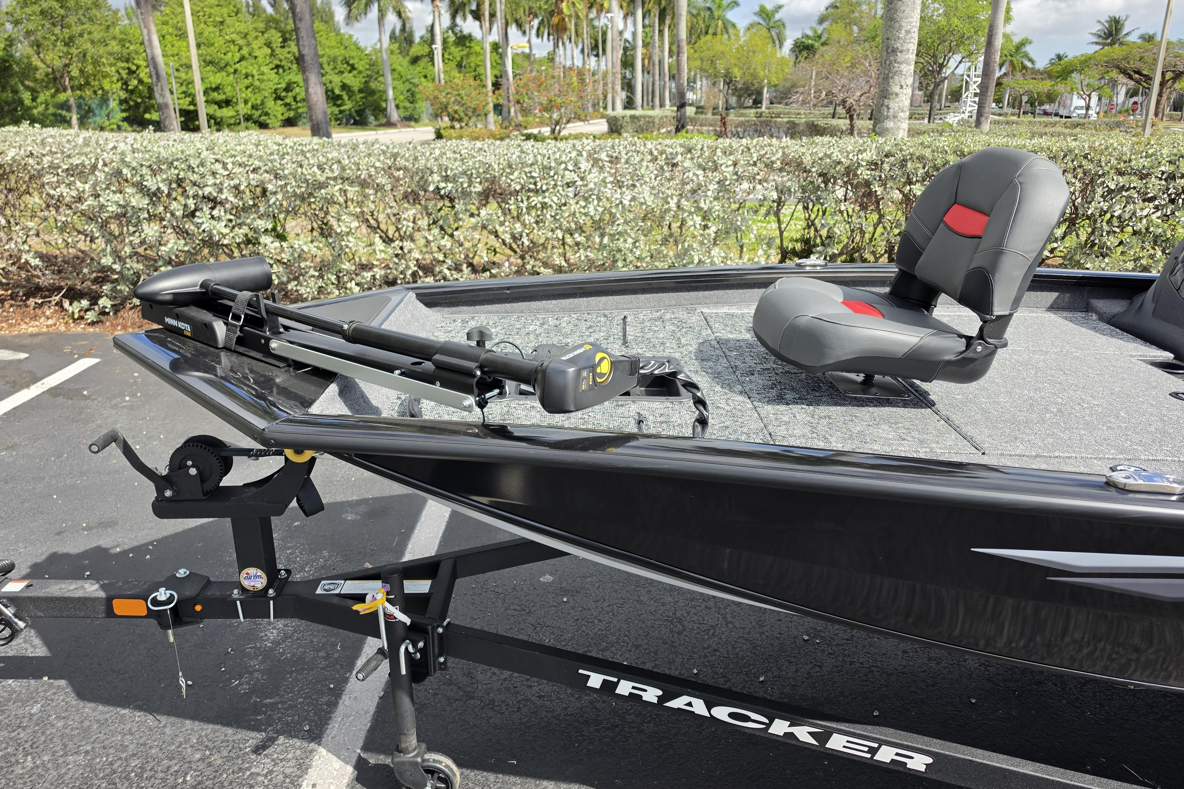 2026 Tracker Pro Team 190 boat with seating and trolling motor in a scenic outdoor setting.