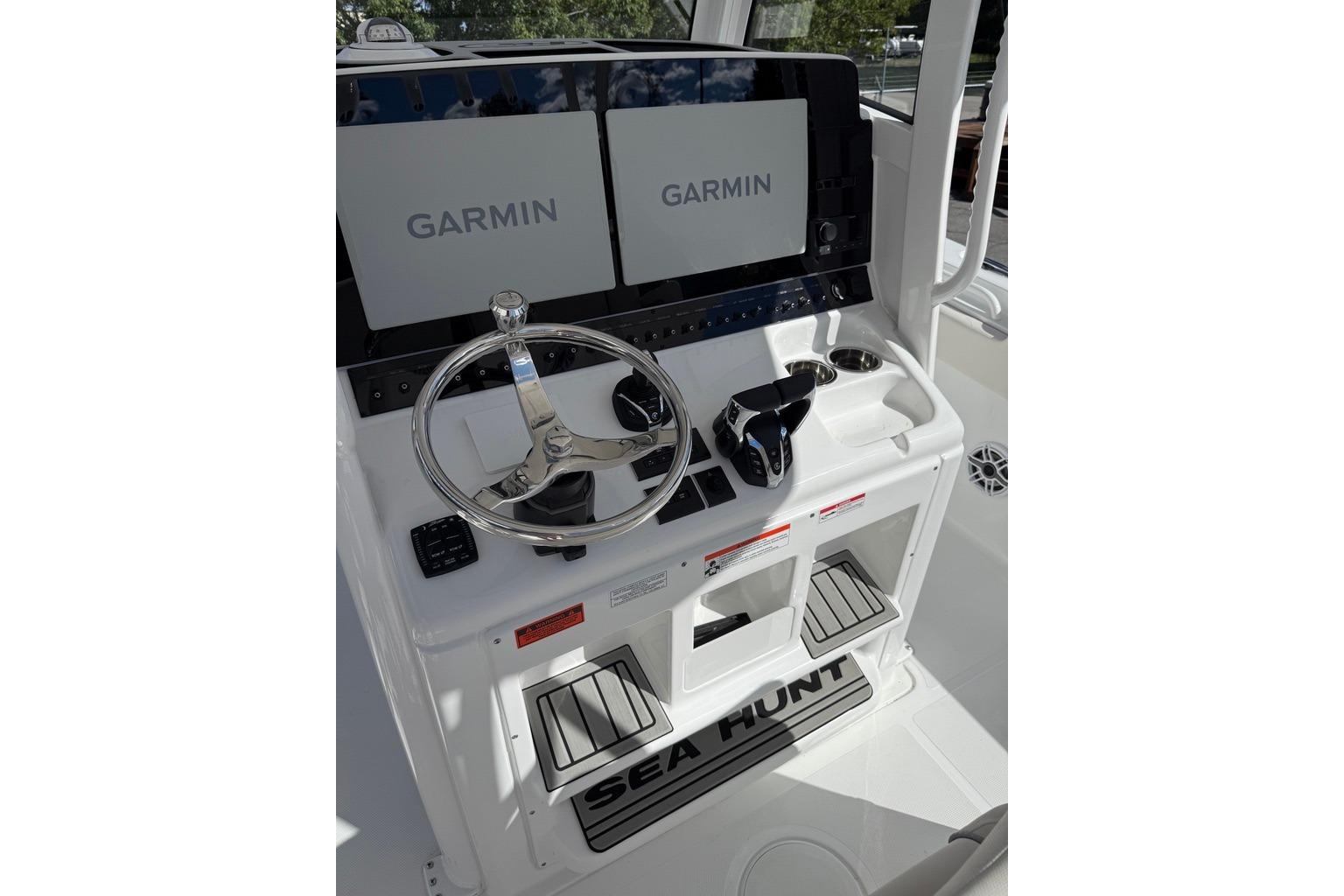 Steering console of 2026 Sea Hunt Ultra 285 Coffin Box with Garmin displays.