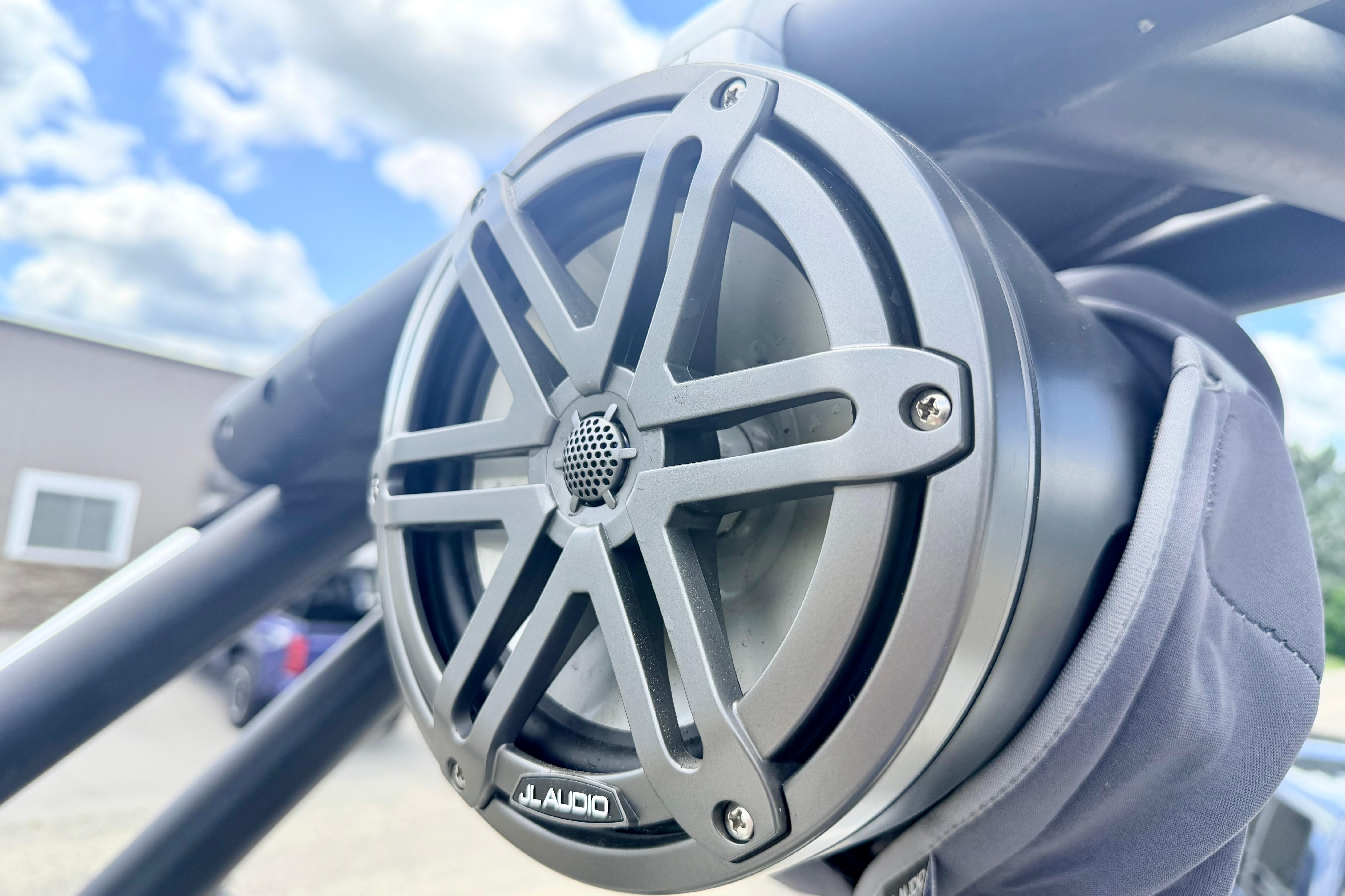 Close-up of JL Audio speaker on 2018 Glastron GT 185 boat, under a blue sky.