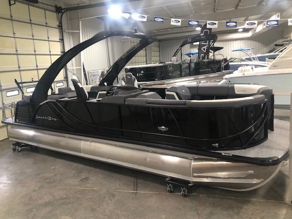 2023 South Bay 525 RS 3.0 Arch pontoon boat in a warehouse.