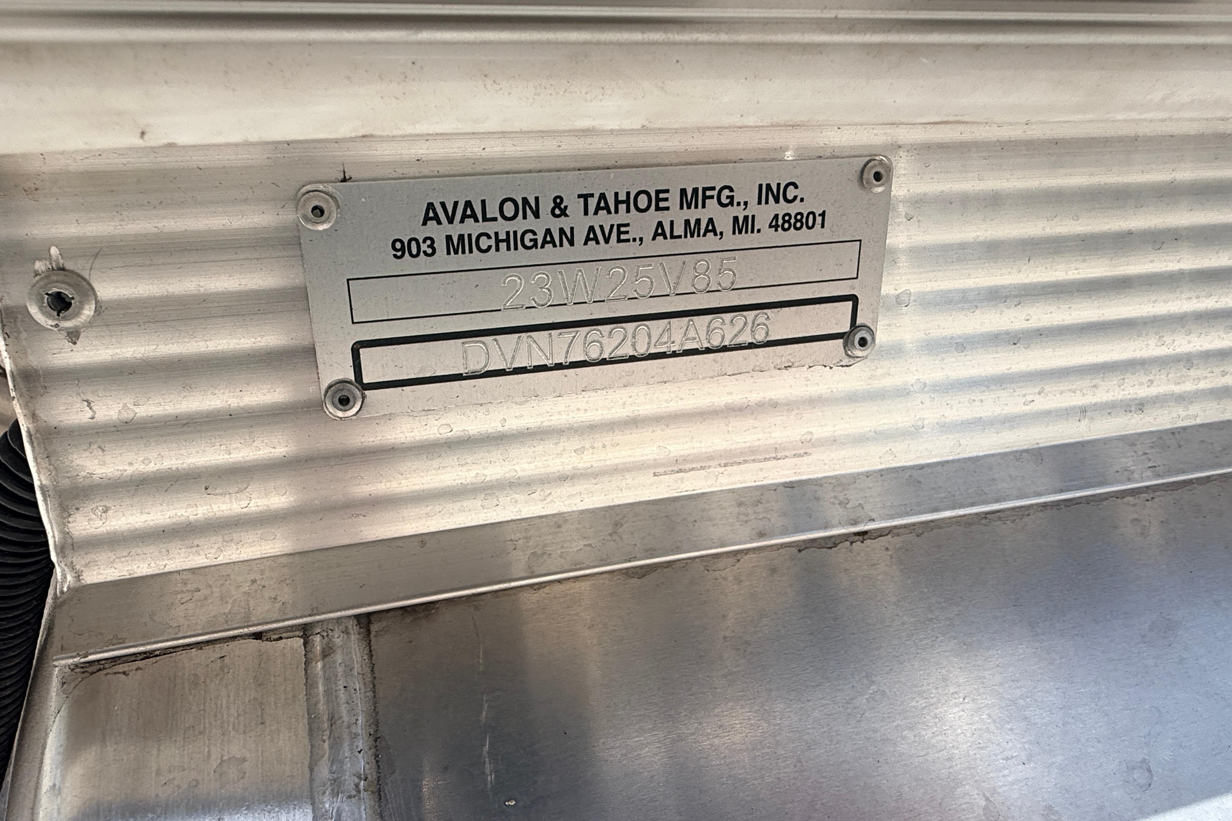 Metal identification plate on Avalon 2385 Venture 85 Rear Fish, Tri Toon, High Performance, 2026 model.