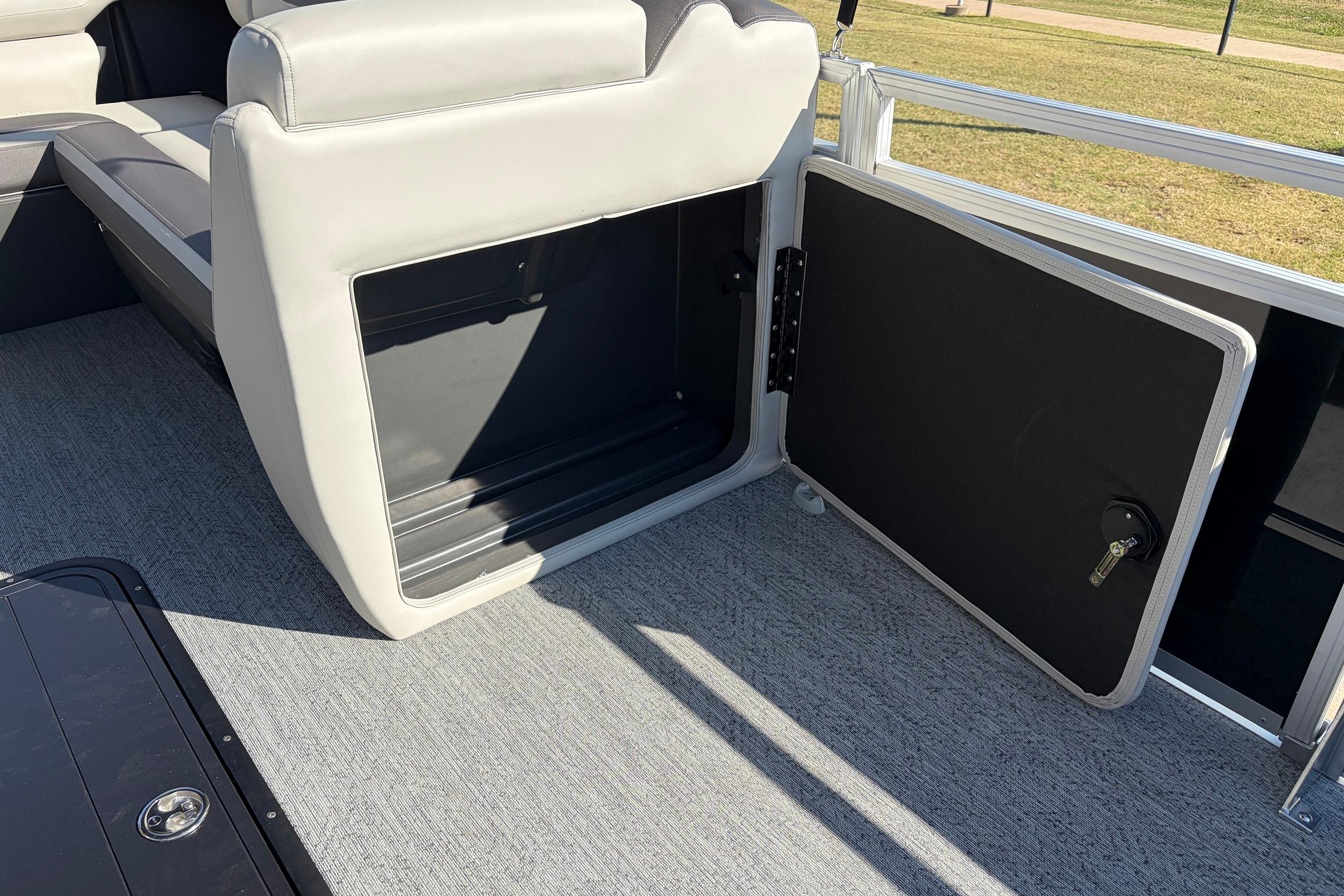 2026 Sun Tracker Fishin' Barge 22 XP3 storage compartment with open door on deck.