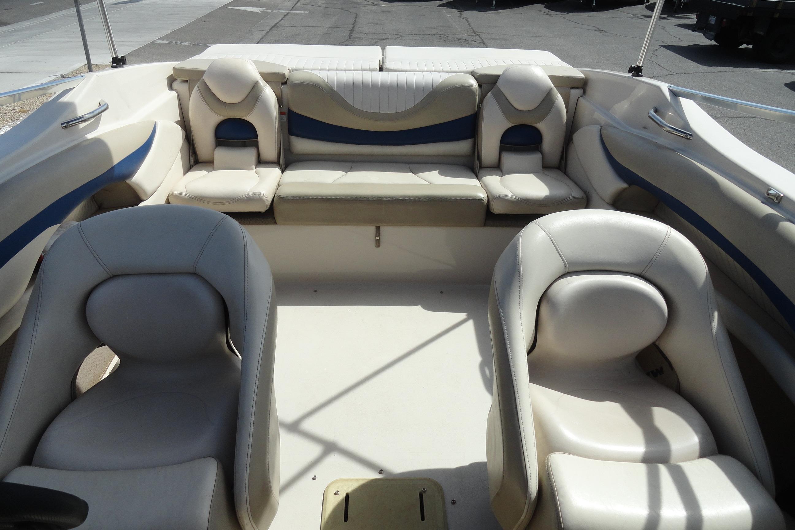 2004 Glastron GX 205 Ski & Fish boat interior with beige seating and blue accents.