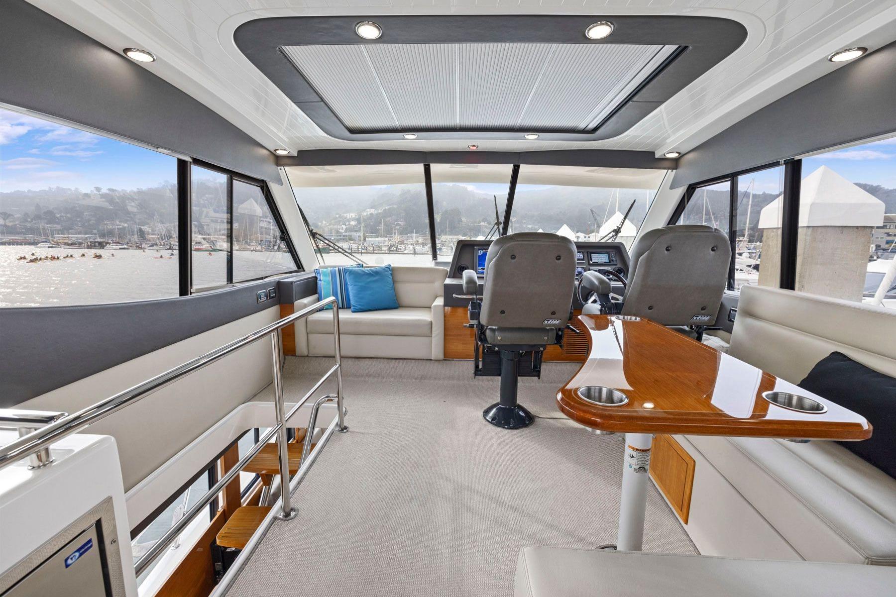 Luxurious interior of 2014 Maritimo M50 yacht with panoramic windows and elegant seating.