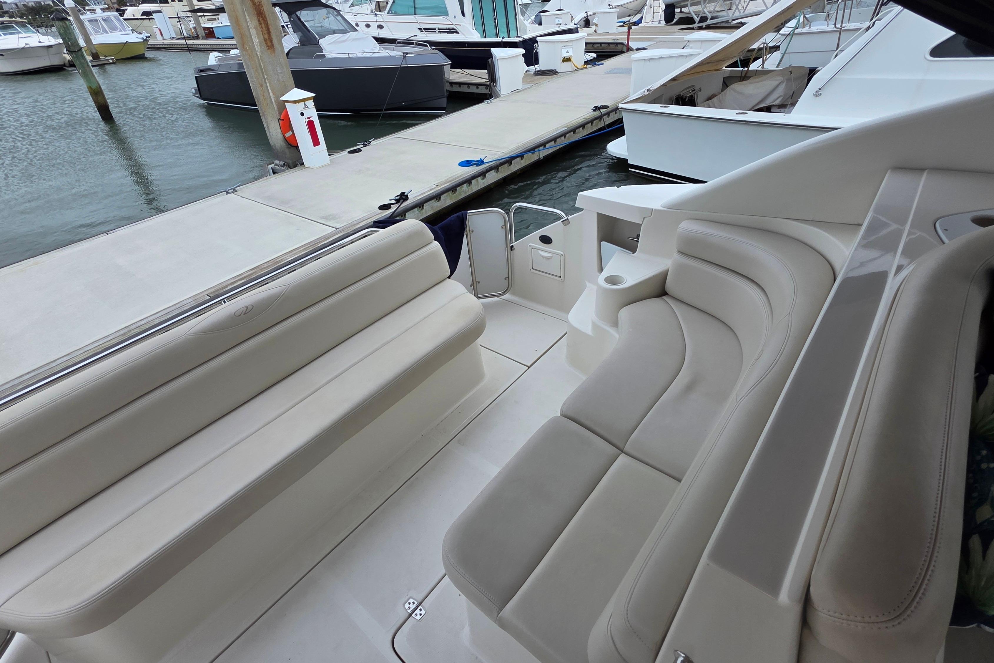 2002 Regal Commodore 4260 yacht interior with beige seating at marina dock.