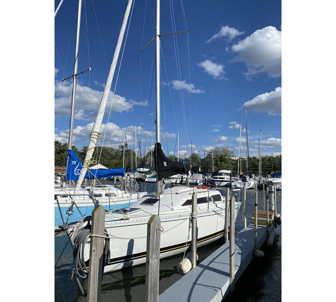 Sailboat docked at marina under blue sky, Kirie 286 model, 1988.