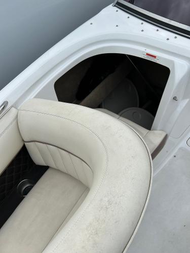 2010 Cobalt 262 boat interior with white leather seating and storage compartment.