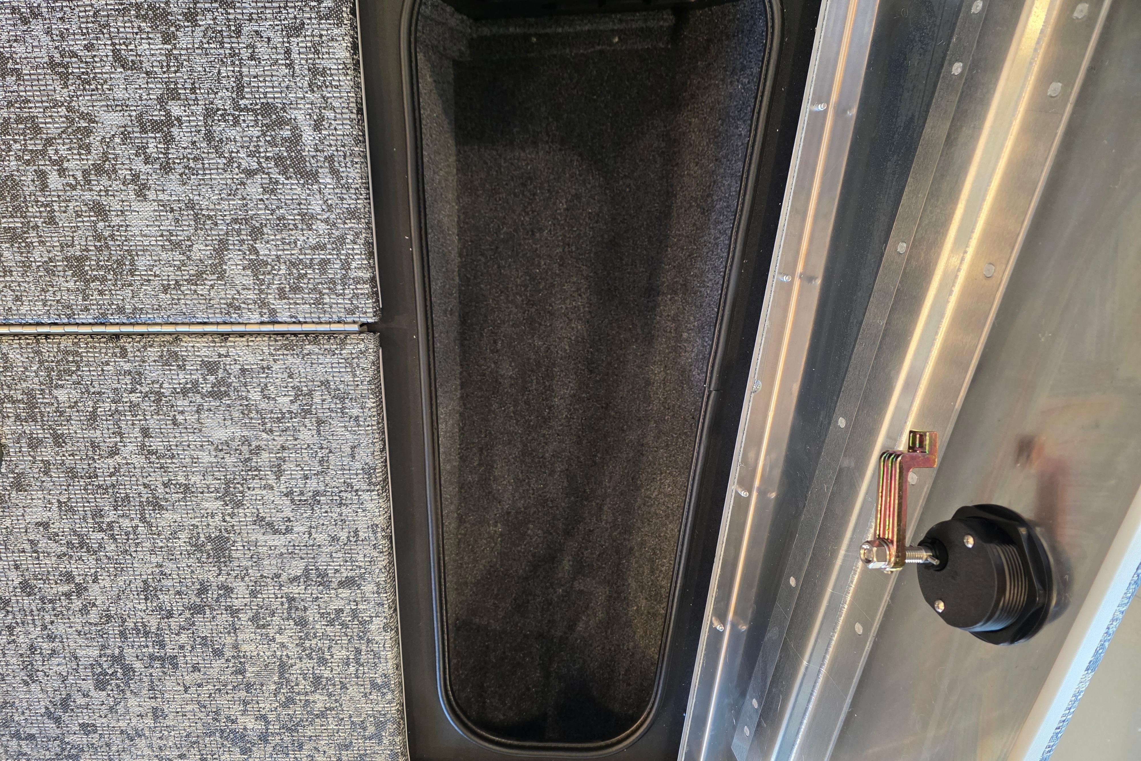 2026 Tracker Pro Team 175 Crappie Edition boat storage compartment with textured flooring.