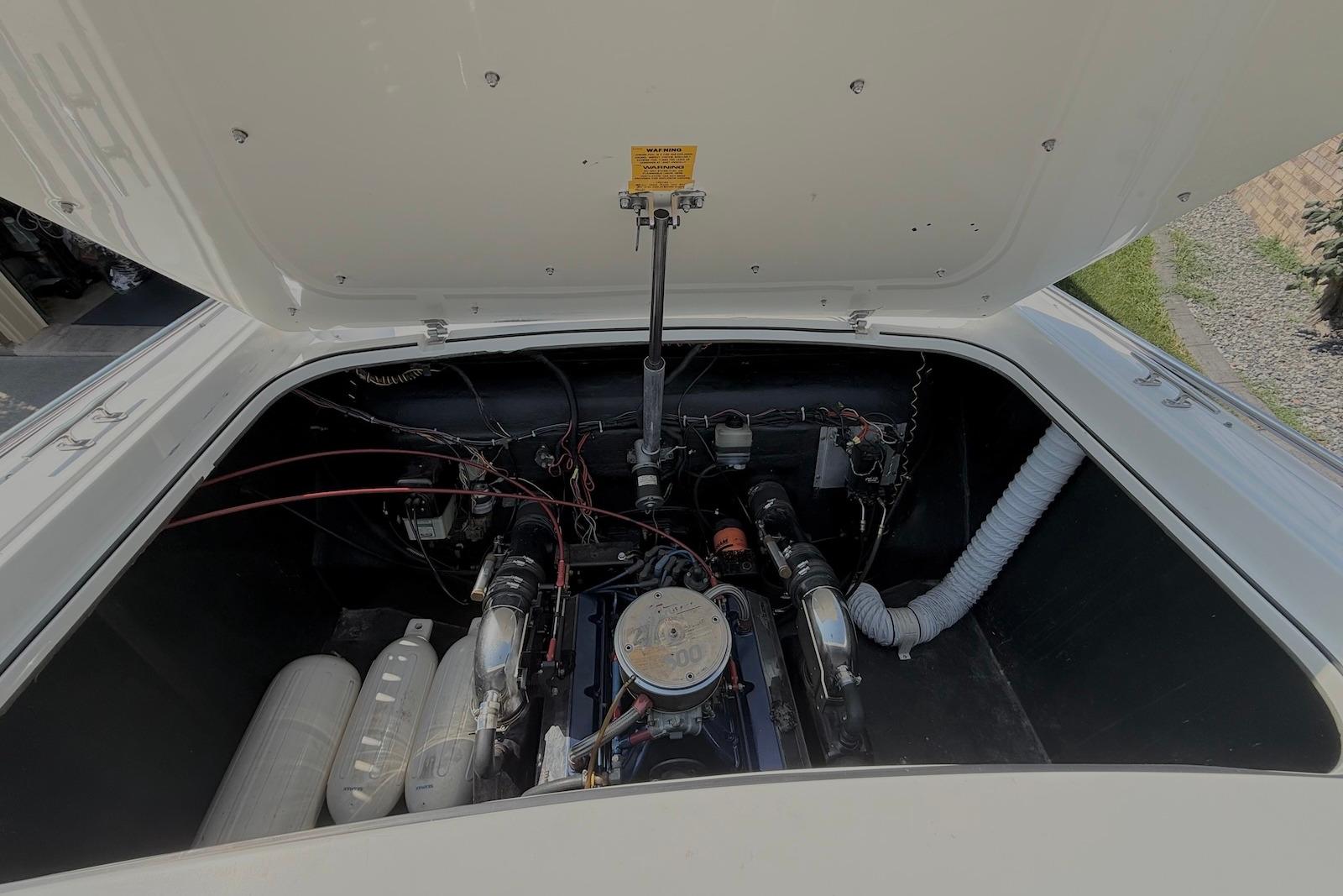 Engine compartment of a 1995 Checkmate Persuader 261 boat, showing detailed components.