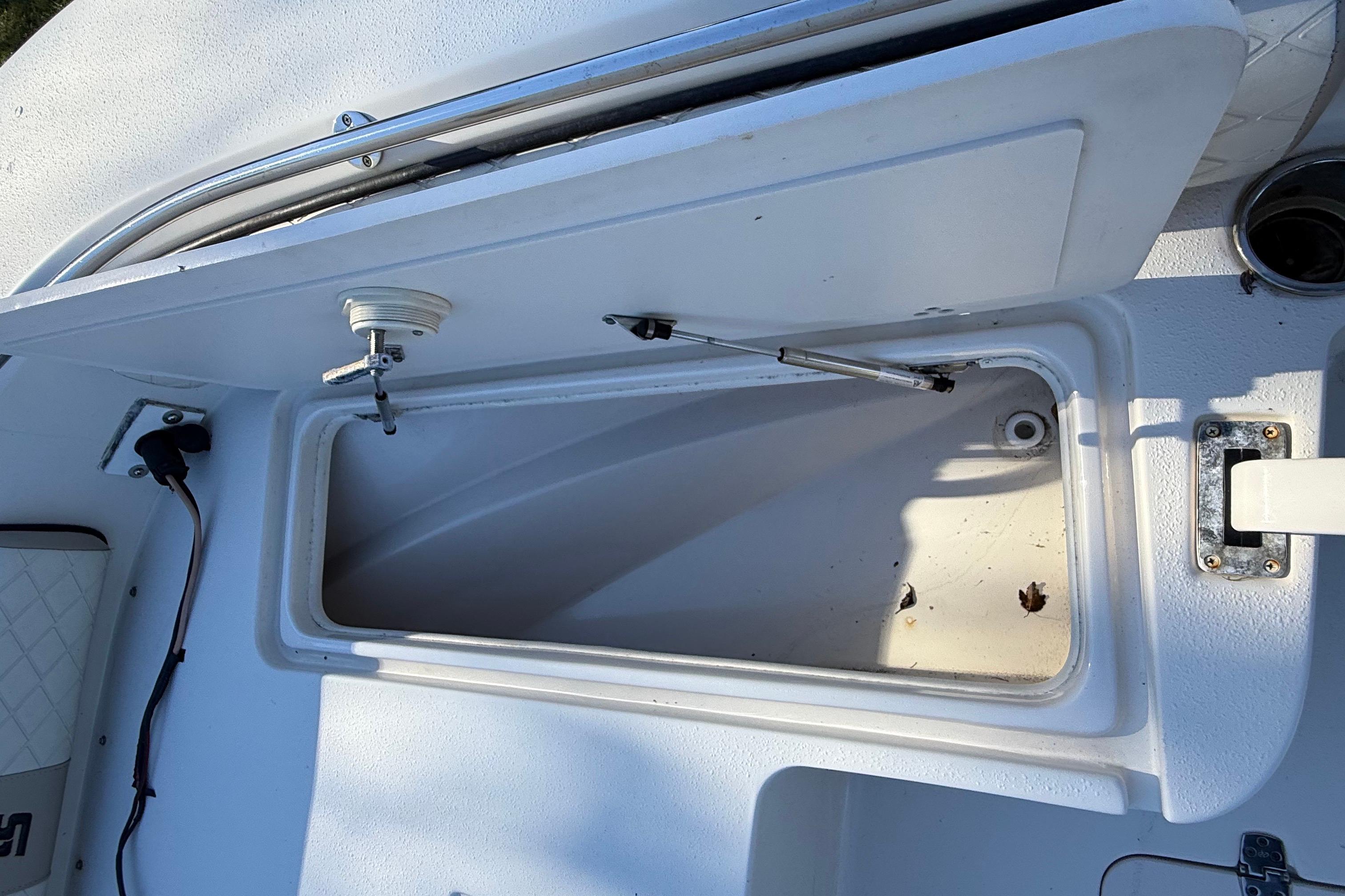 Open storage compartment on 2021 Carolina Skiff 26 Ultra Elite boat deck.