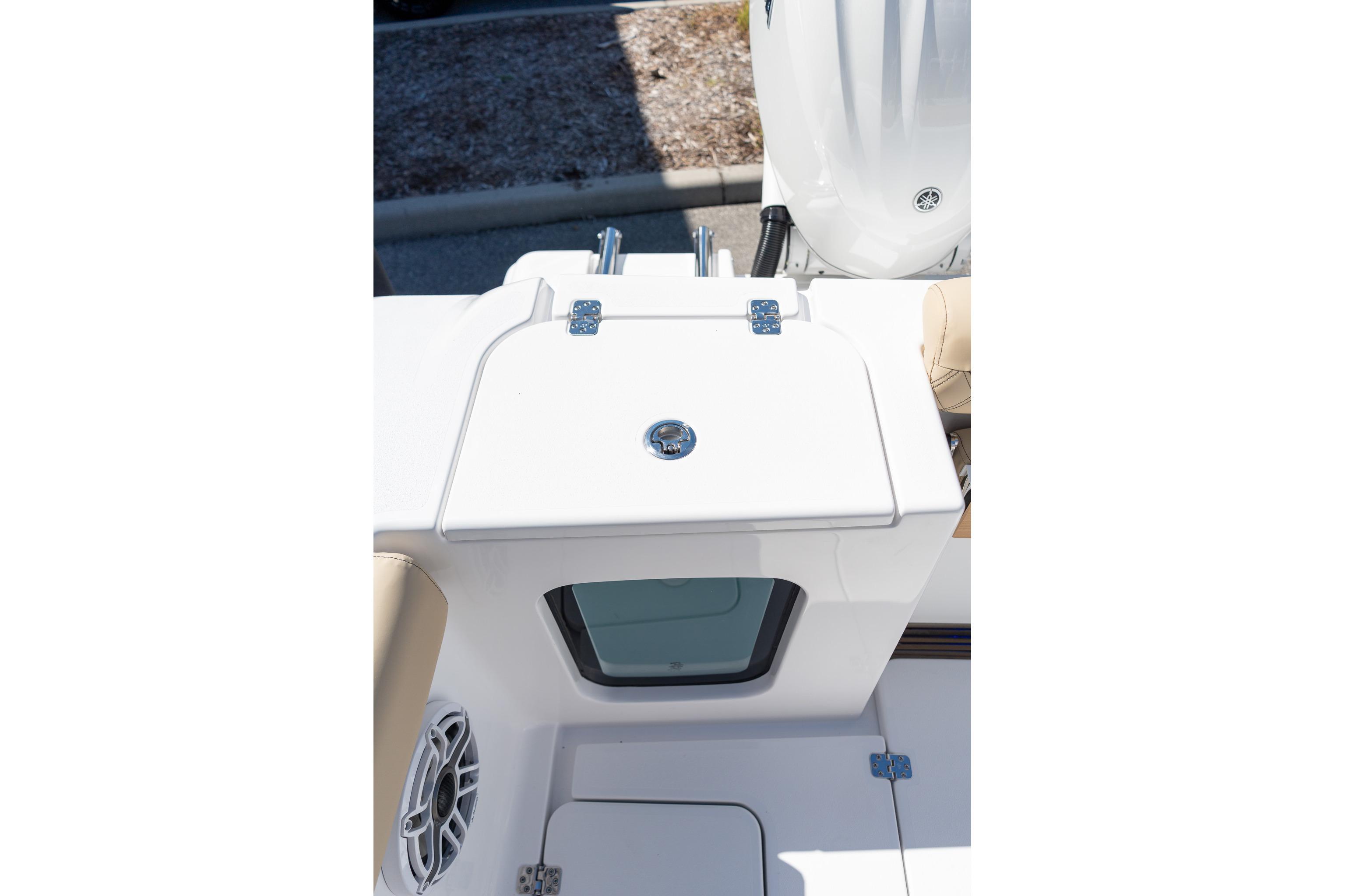 2026 Sportsman Open 282 Center Console boat deck with storage compartment and speaker.