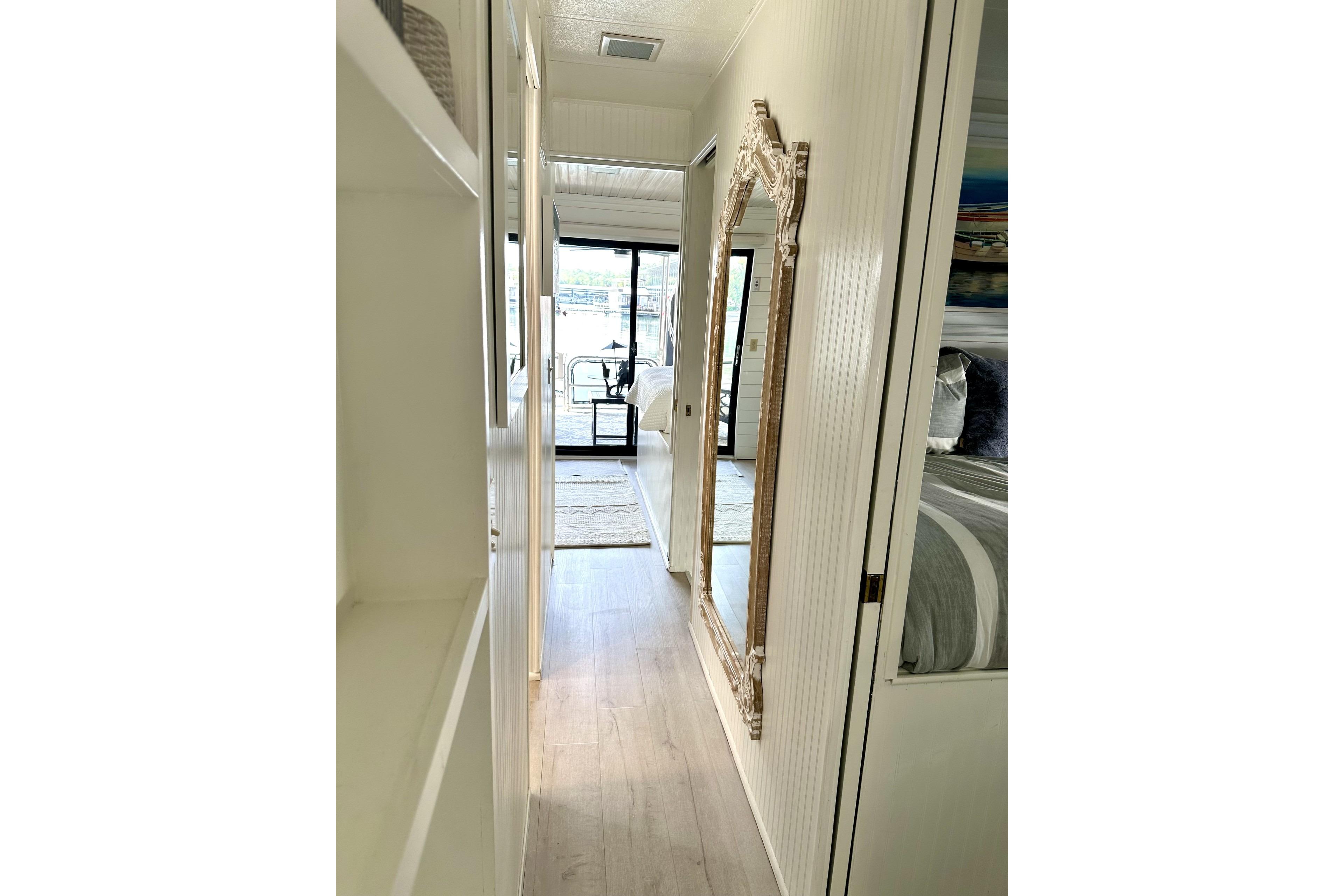 Narrow hallway in 1992 Sumerset 66 houseboat with elegant mirror and cozy interior.