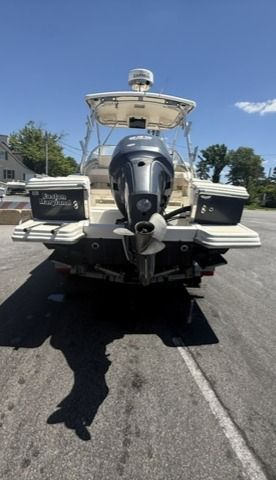 A 2004 Scout 242 Abaco boat is parked on a lot. The engine is visible.