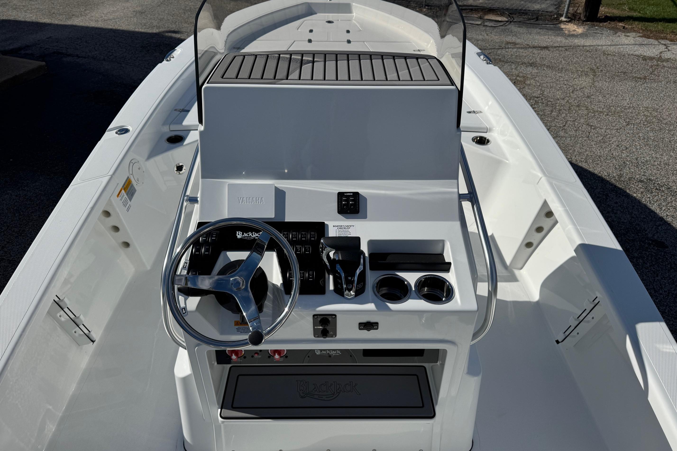 2026 BlackJack 256 Bay boat console with steering wheel and controls.