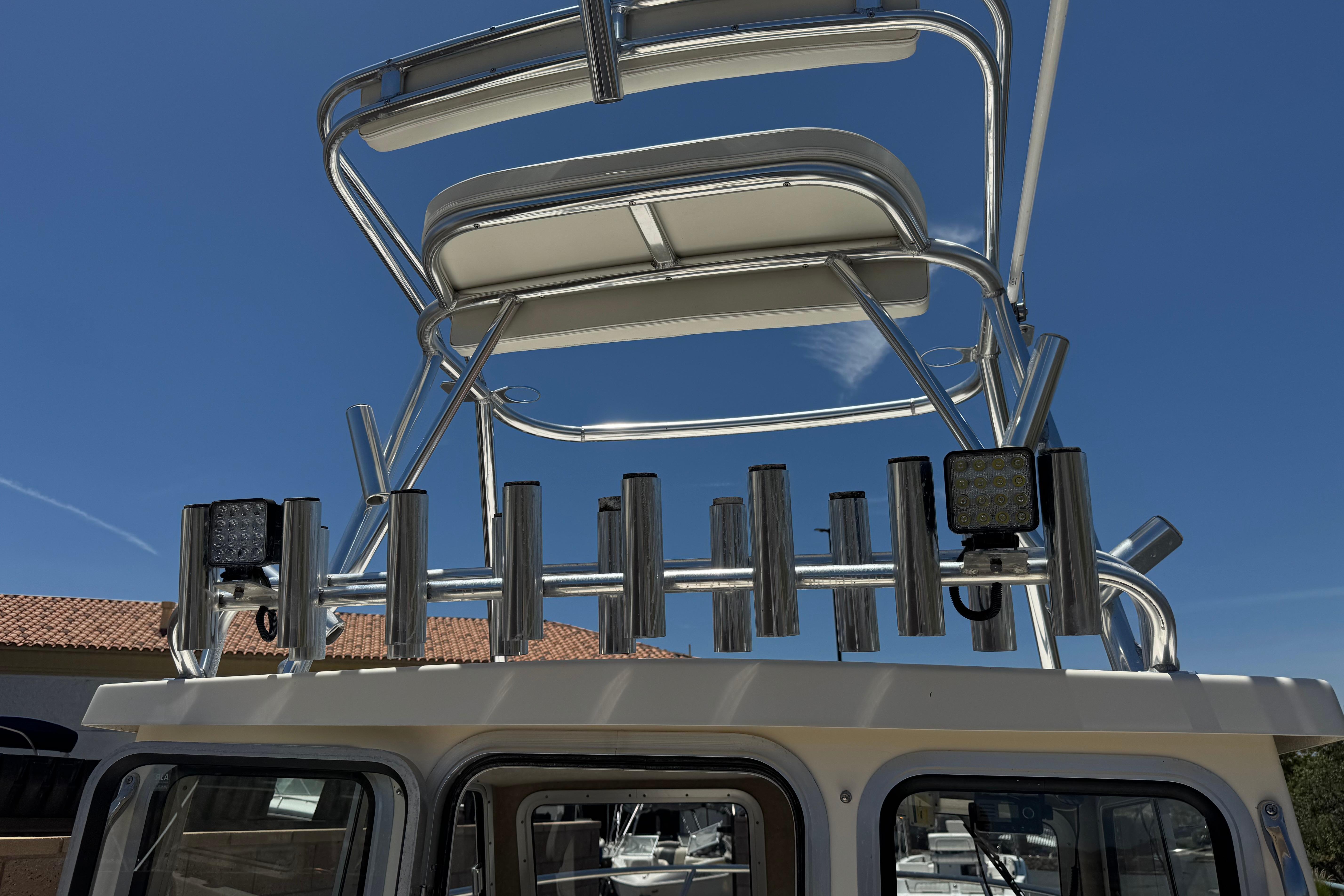 2017 Defiance Admiral 220 EX boat tower with rod holders and lights under clear blue sky.