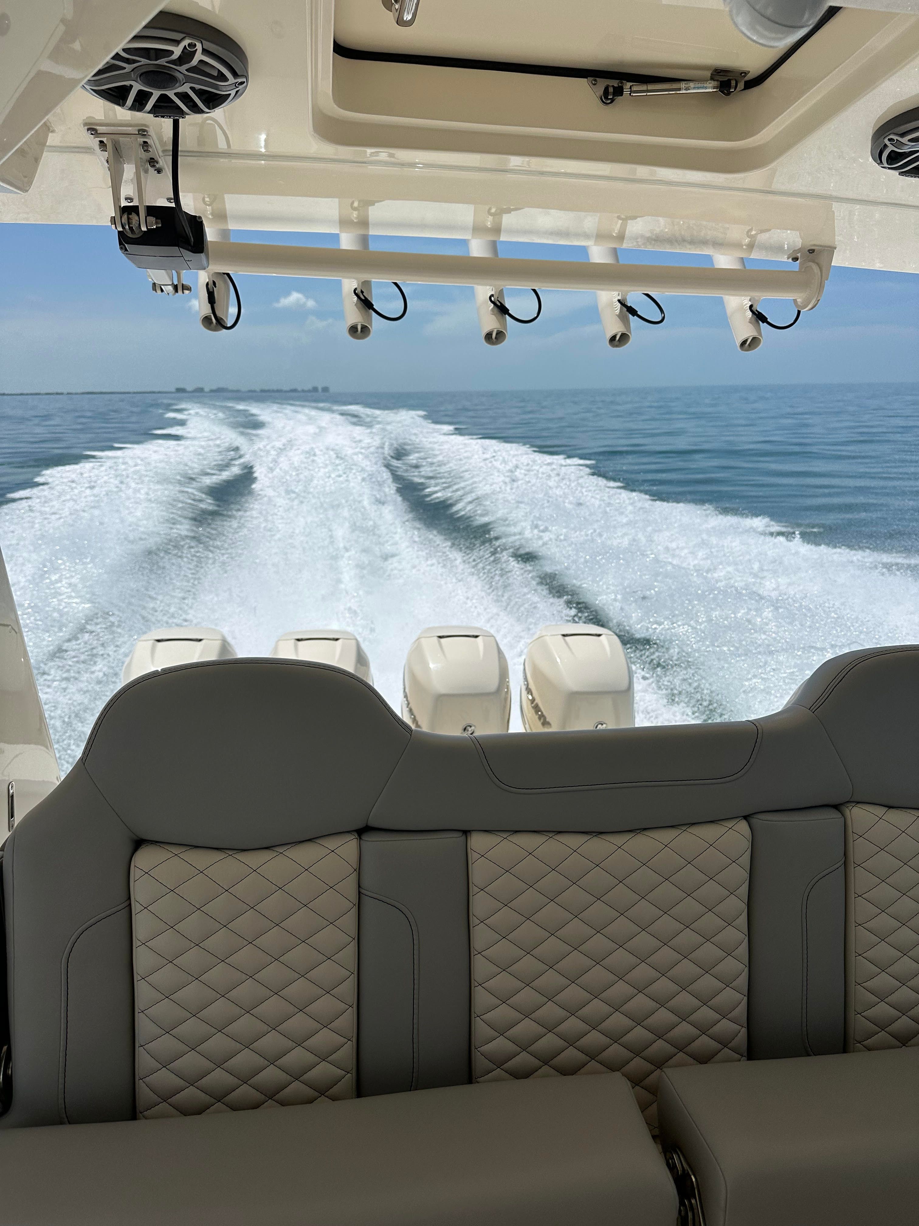 Scout 425 LXF 2022 on water with engines in background.