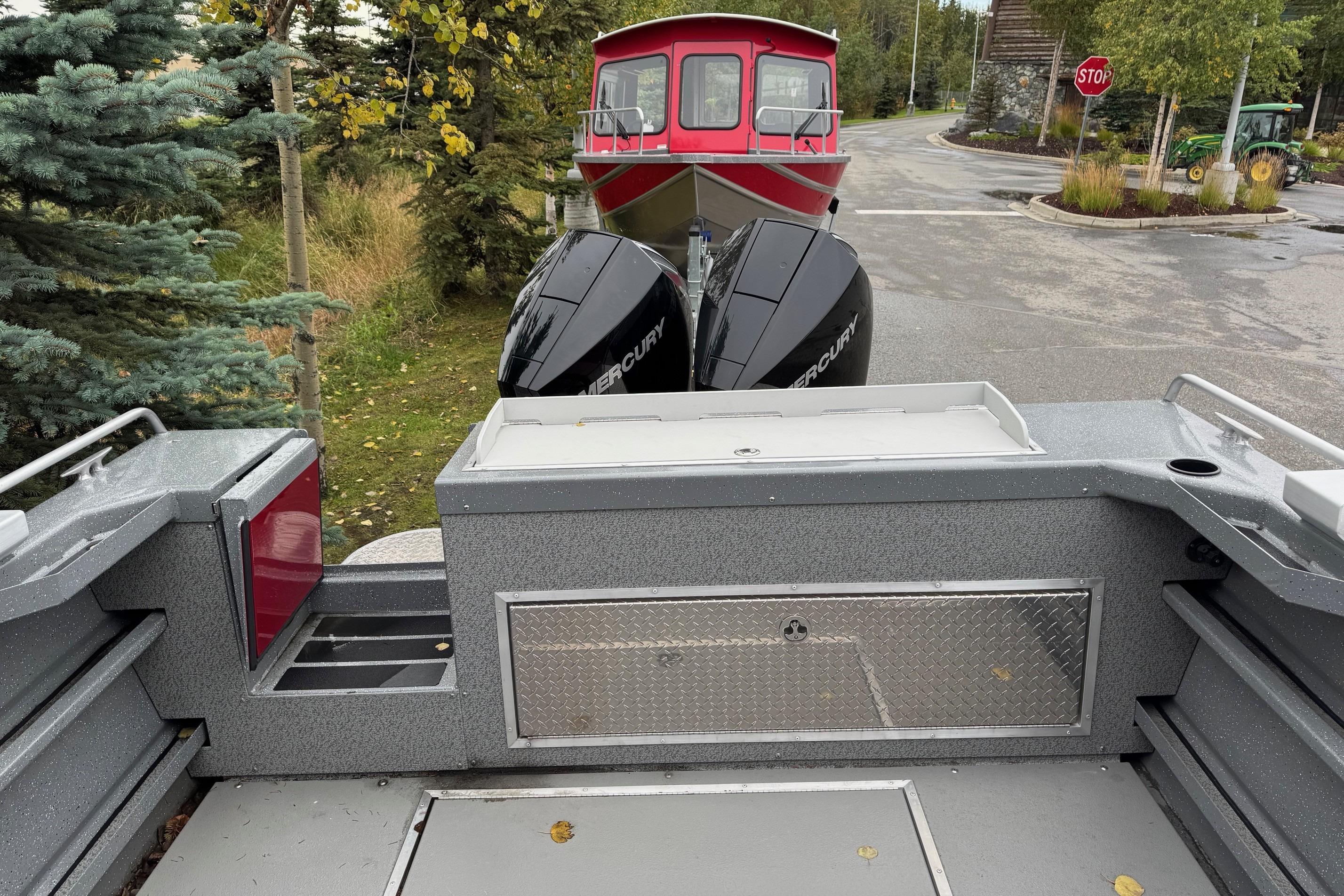 2024 Spartan 24 MAXIMUS PRO XL boat with dual Mercury engines, parked outdoors.