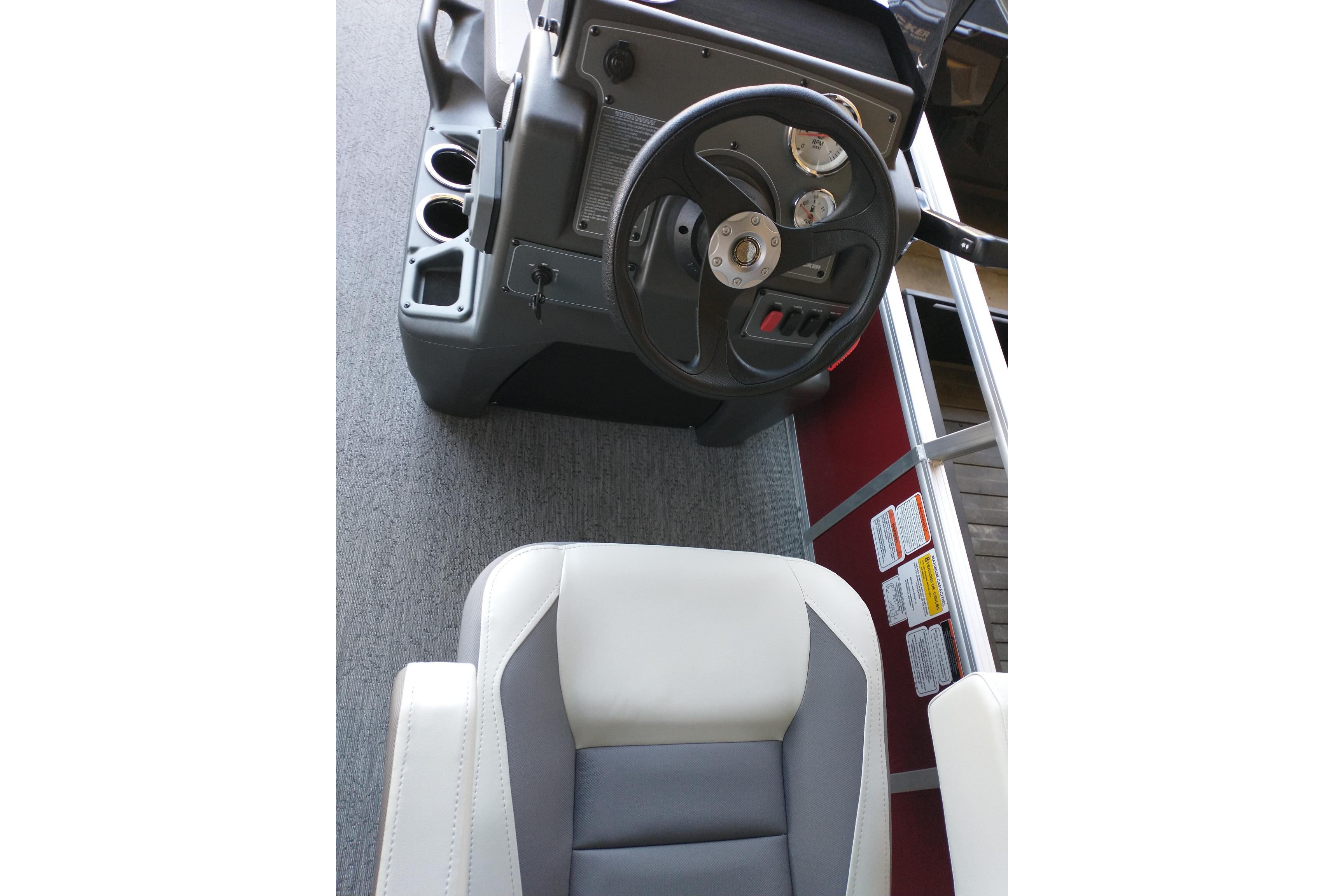 Interior view of 2026 Sun Tracker Bass Buggy 18 DLX boat's steering console and seat.