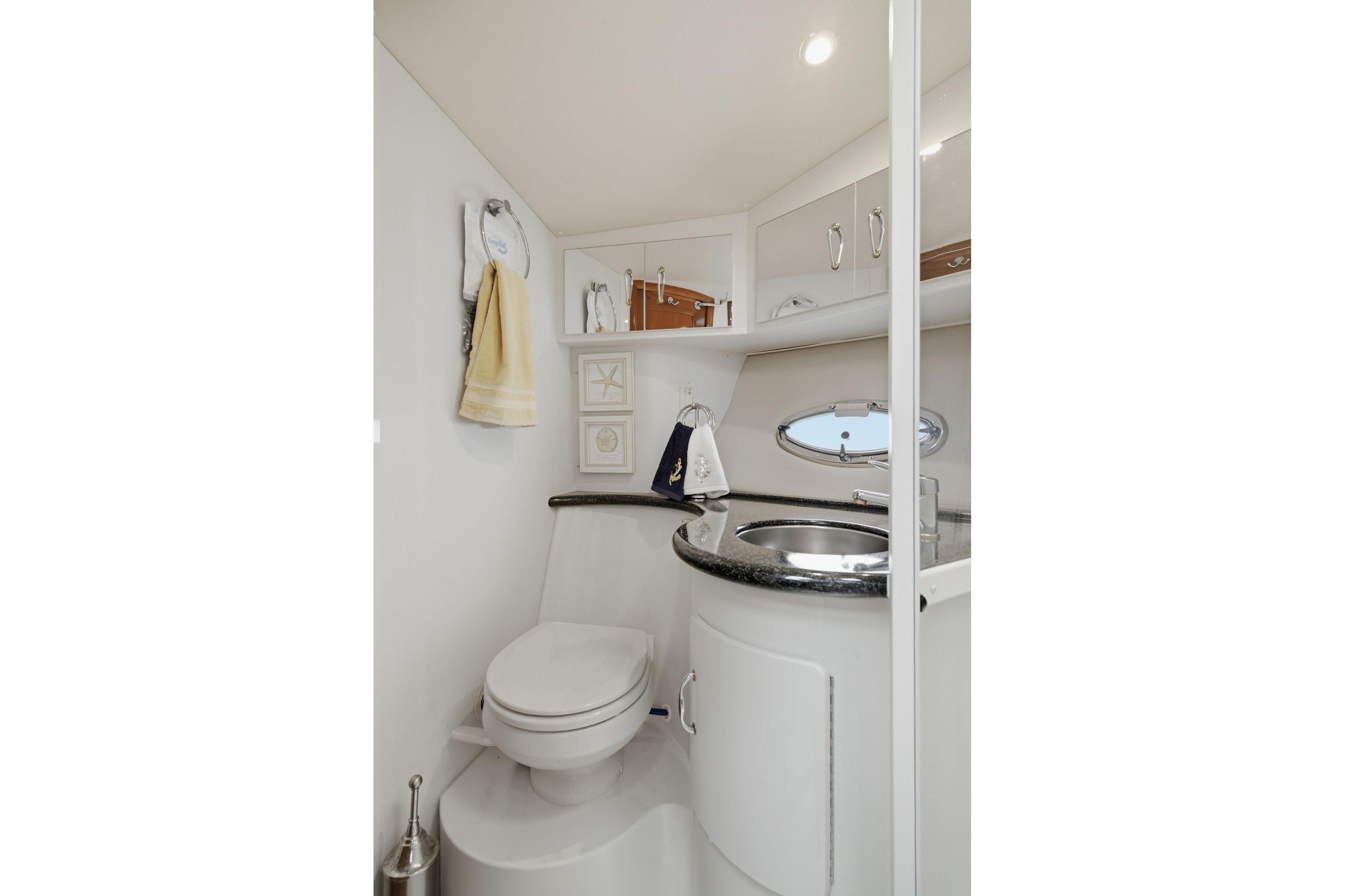 Luxurious bathroom in 2005 Carver 39 Motor Yacht with modern fixtures and elegant design.
