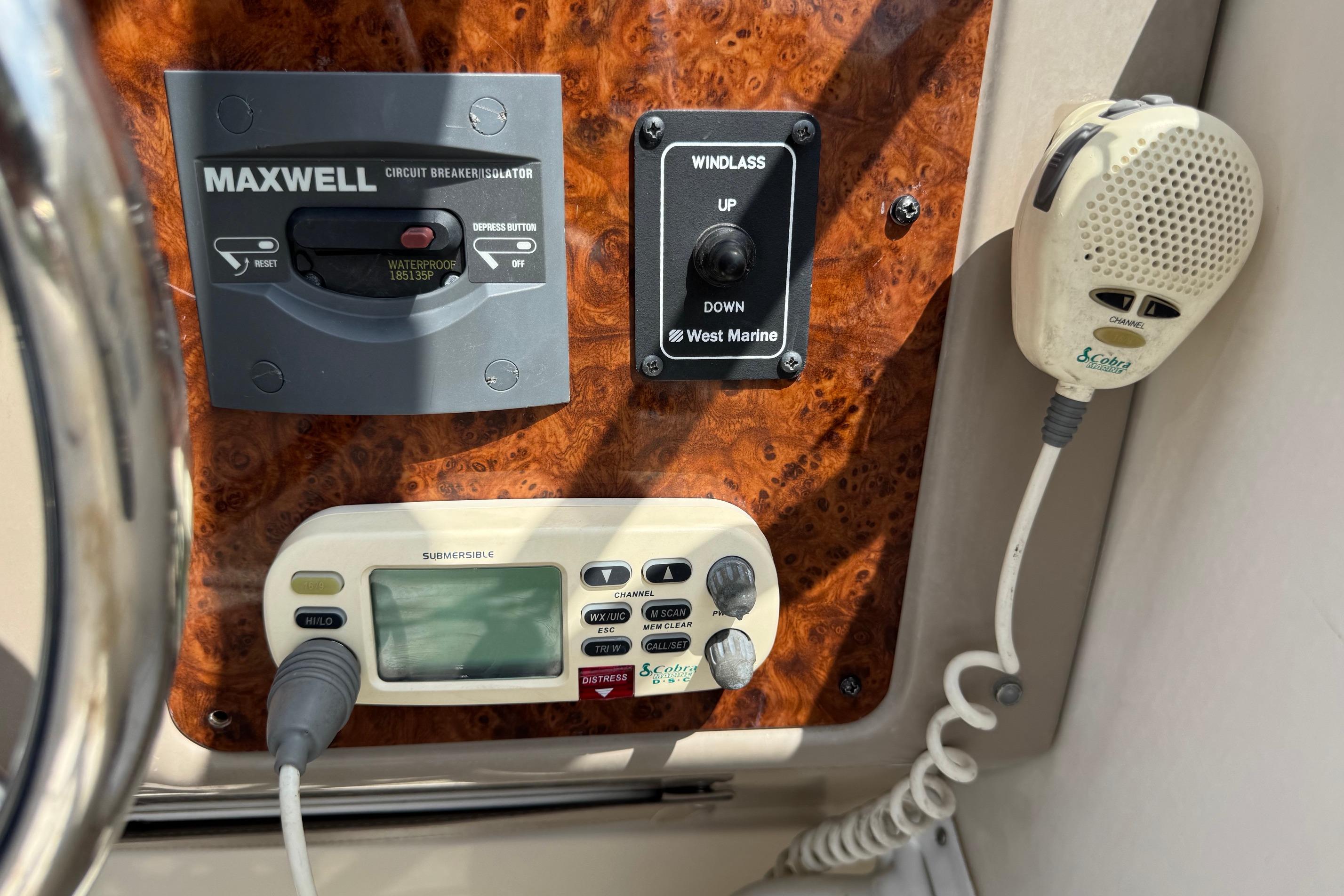 Control panel of a 2000 Maxum 2400 SCR boat with radio and windlass controls.