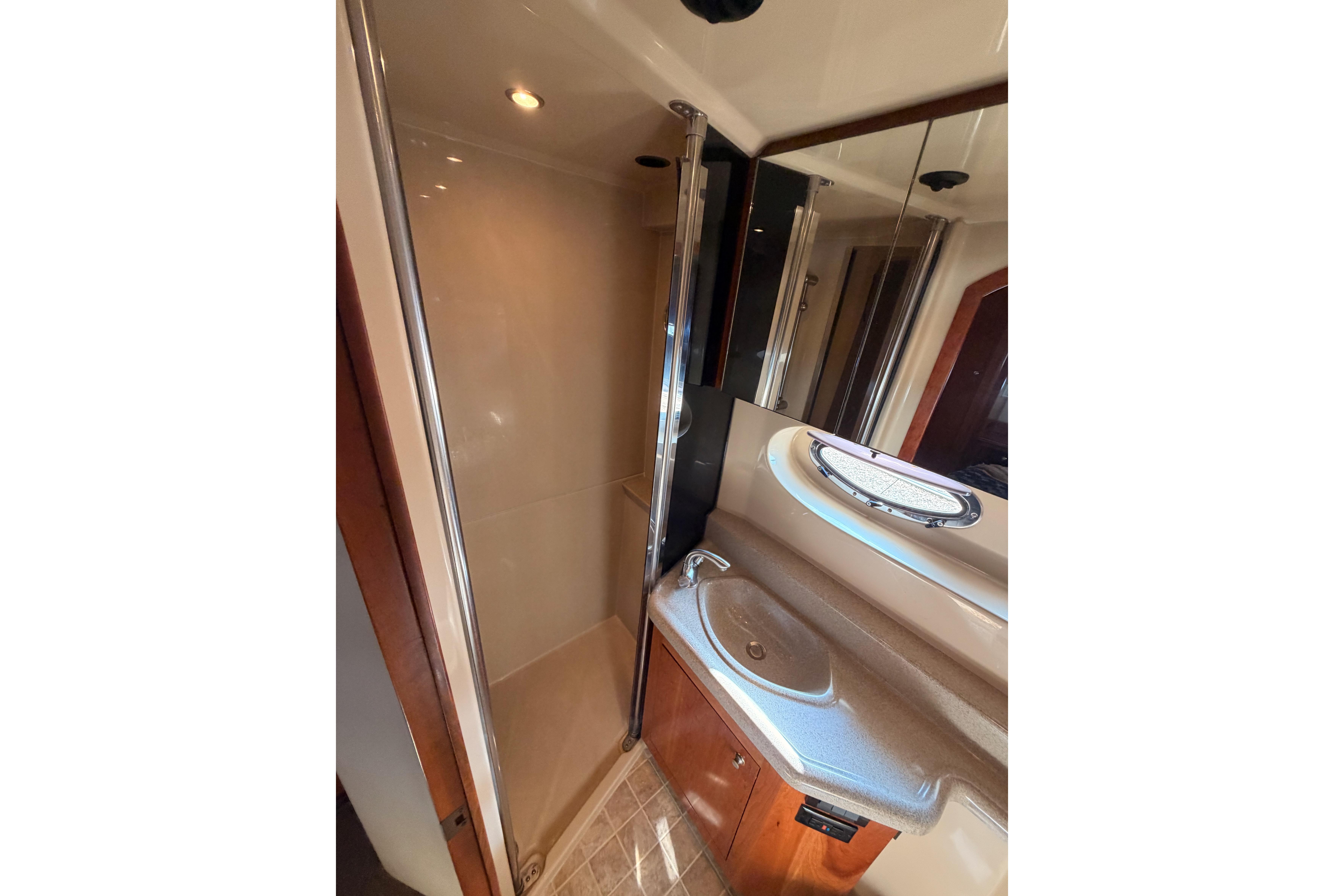2005 Cruisers Yachts 405 Express Motoryacht bathroom with shower and sink.