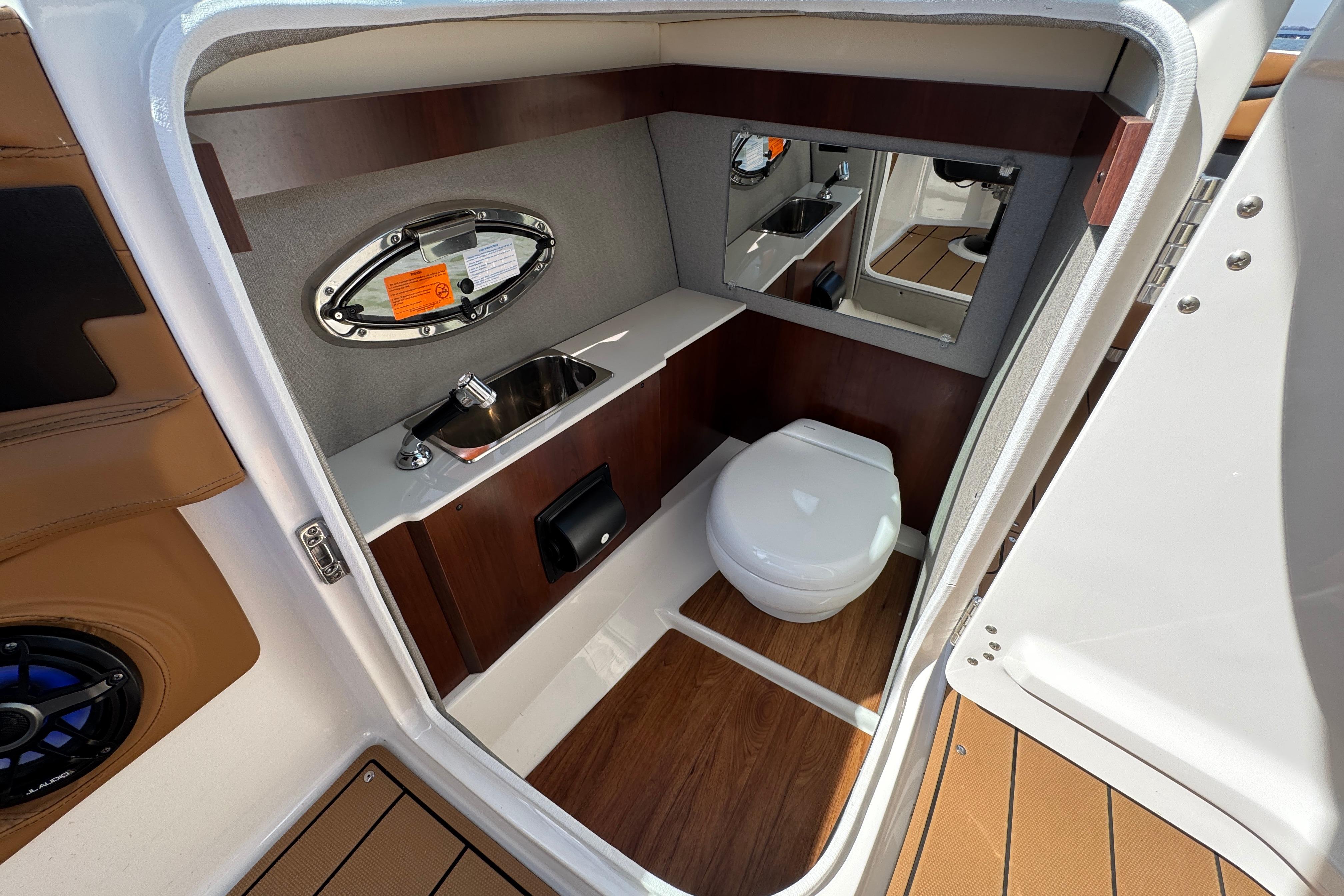 2023 Chaparral 26 Surf boat interior bathroom with sink and toilet.
