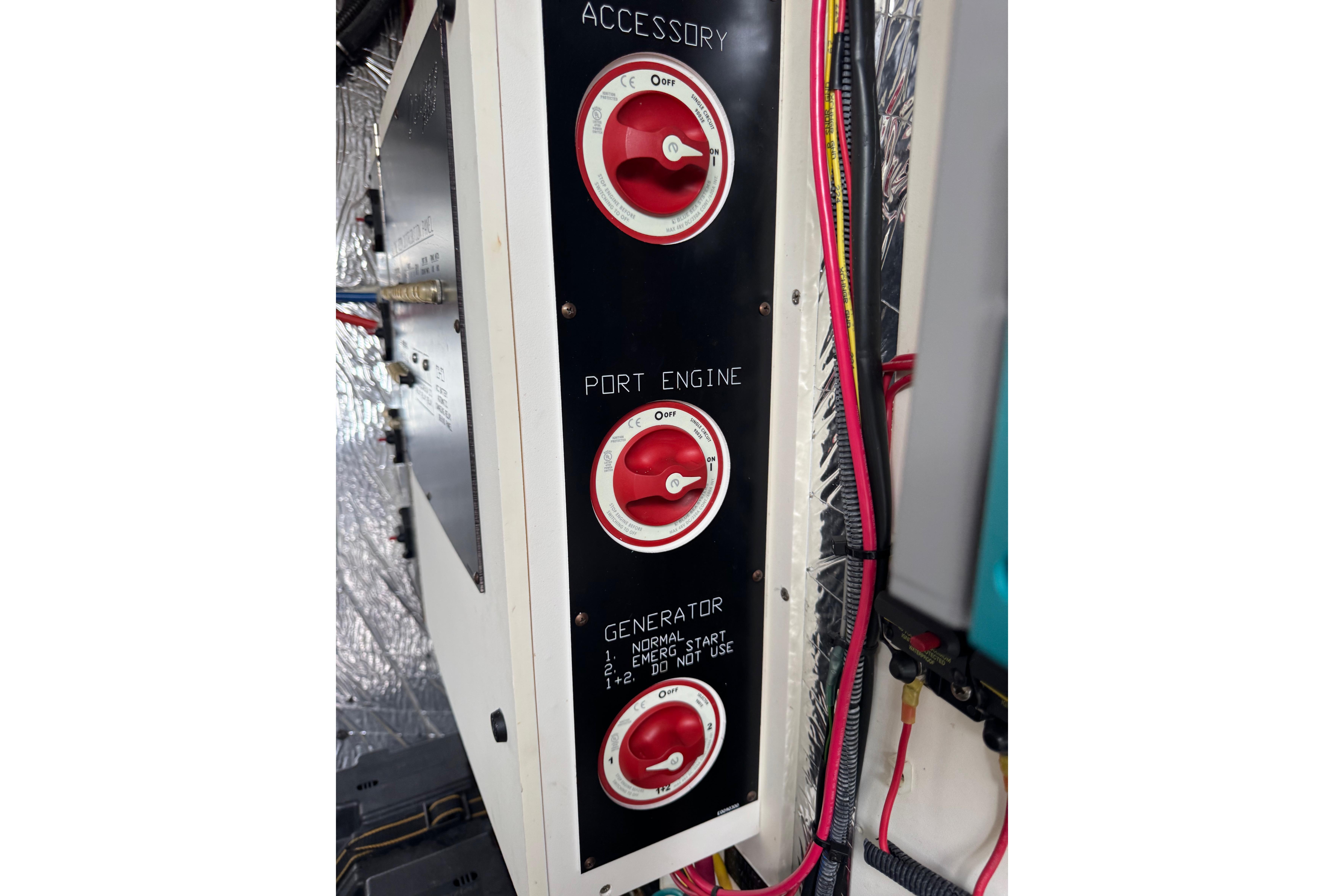 Control panel with red switches on a 2012 Cruisers Yachts 48 Cantius.