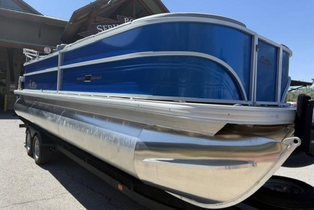 2026 Sun Tracker Party Barge 24 XP3 pontoon boat with blue and silver design.