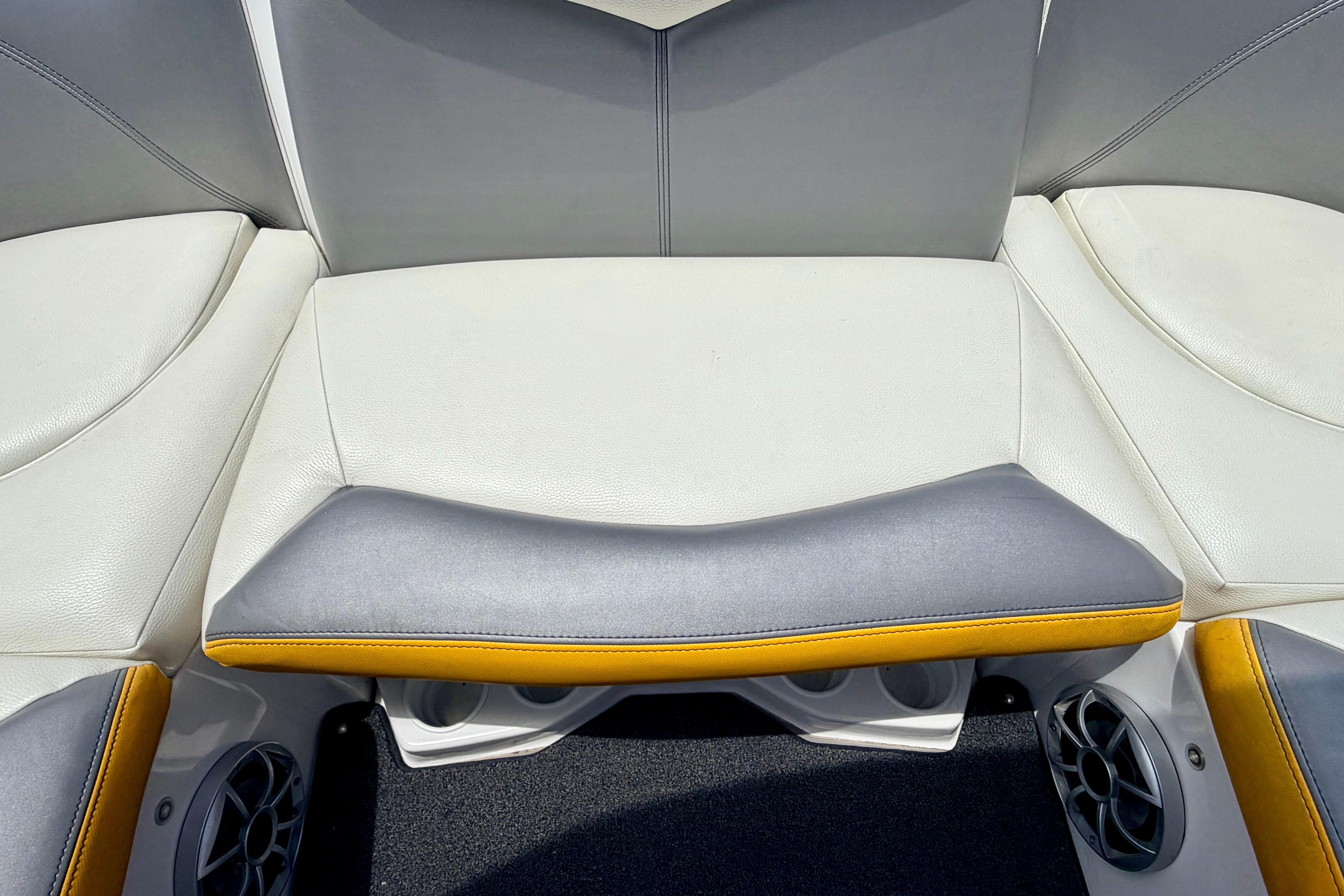 2014 Tigé R20 boat interior seating with gray and yellow accents, featuring built-in speakers.