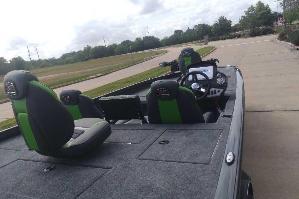 2026 Ranger RT198P boat interior with green-accented seats and steering console on a road.