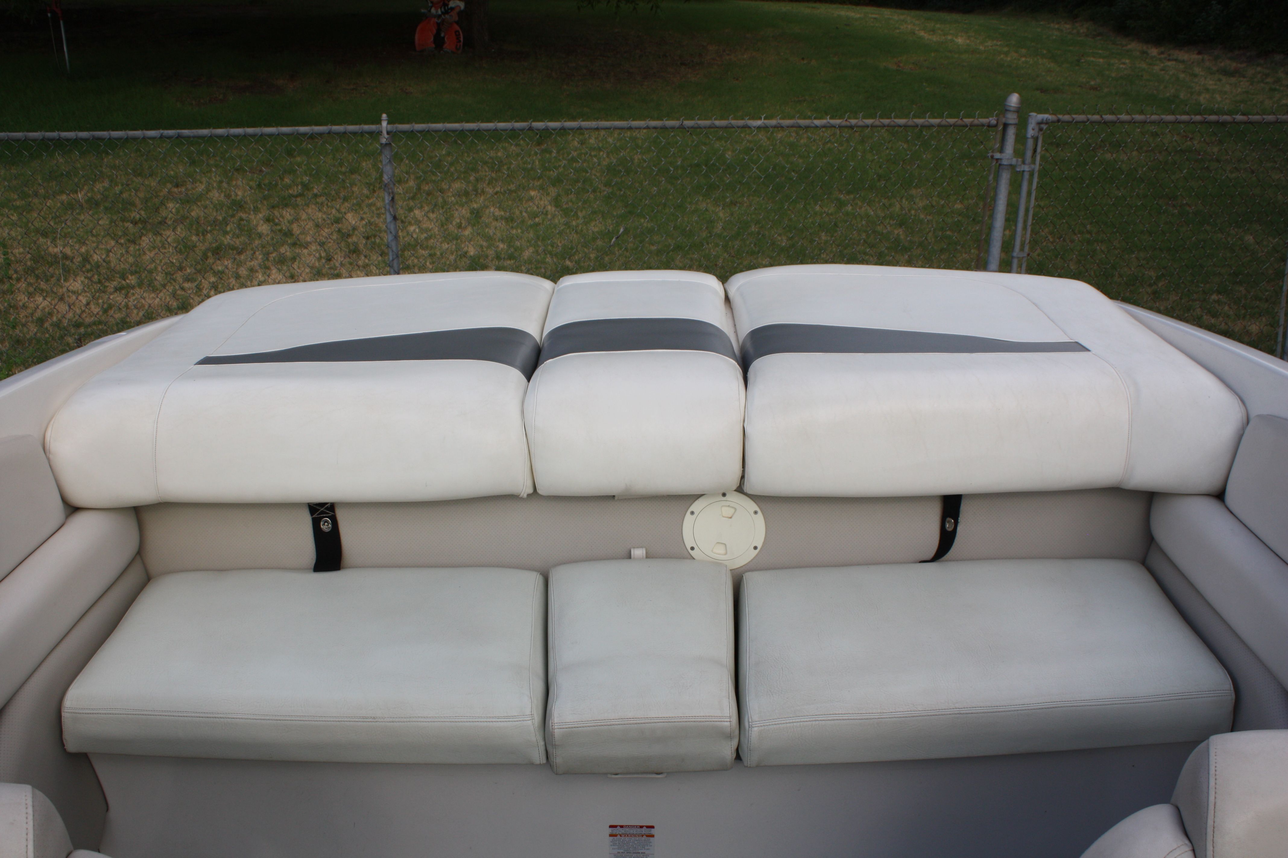 The rear seating of a 2007 Chaparral 210 SSi with white upholstery.