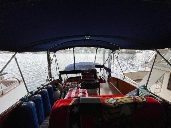 1951 Chris-Craft Catalina boat interior with canopy, docked by the water.