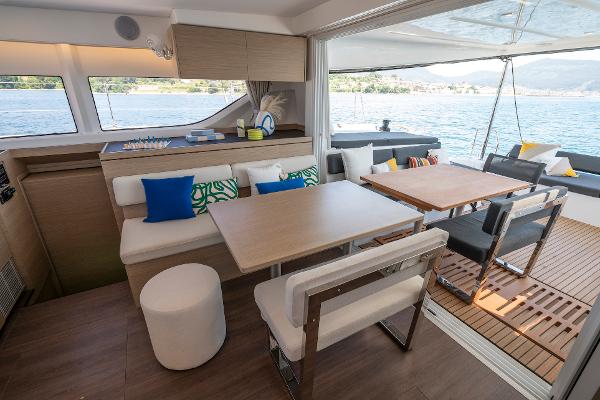 Luxurious interior of 2025 Lagoon 43 yacht with modern seating and scenic water view.