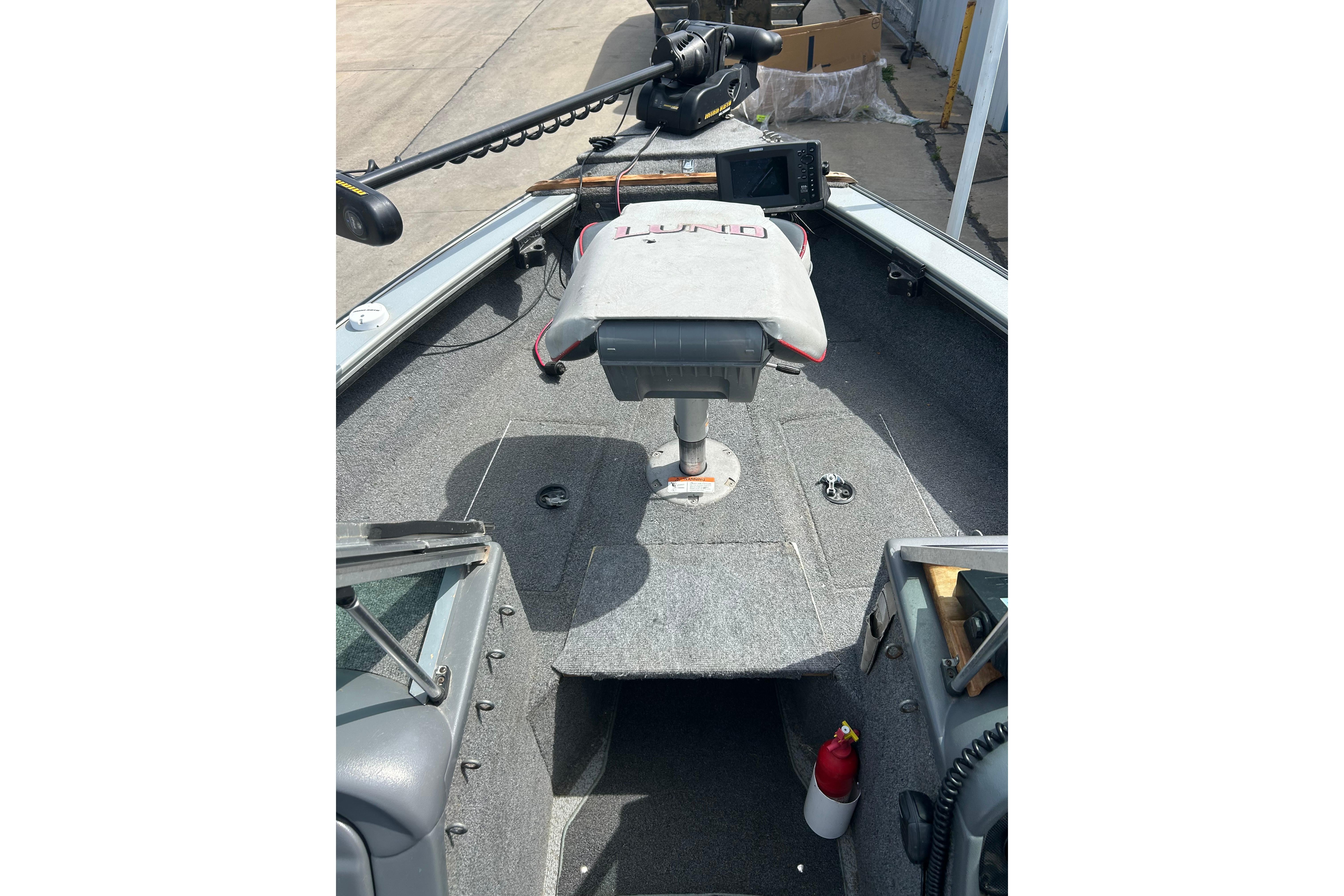 2008 Lund 1850 Fisherman boat interior with seat, control panel, and equipment.
