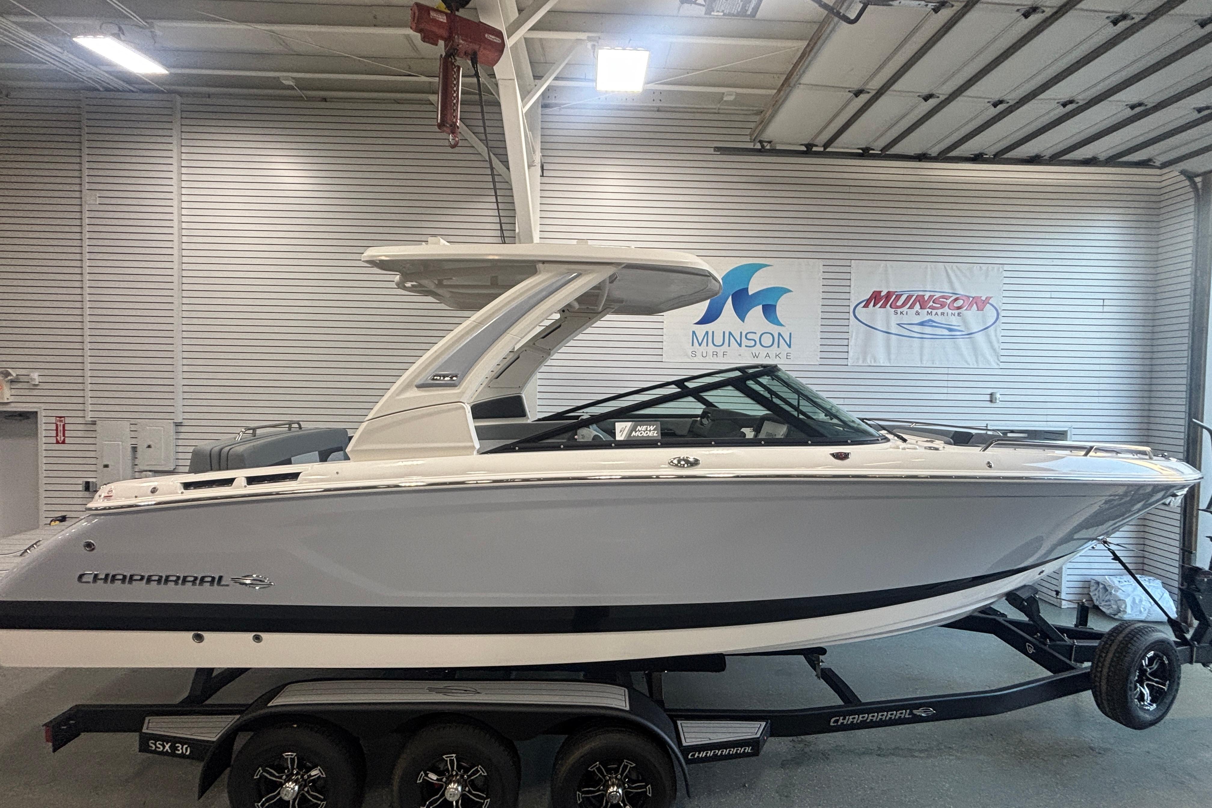2026 Chaparral SSX 30 boat in showroom, displayed on trailer, Munson Surf Wake signage.