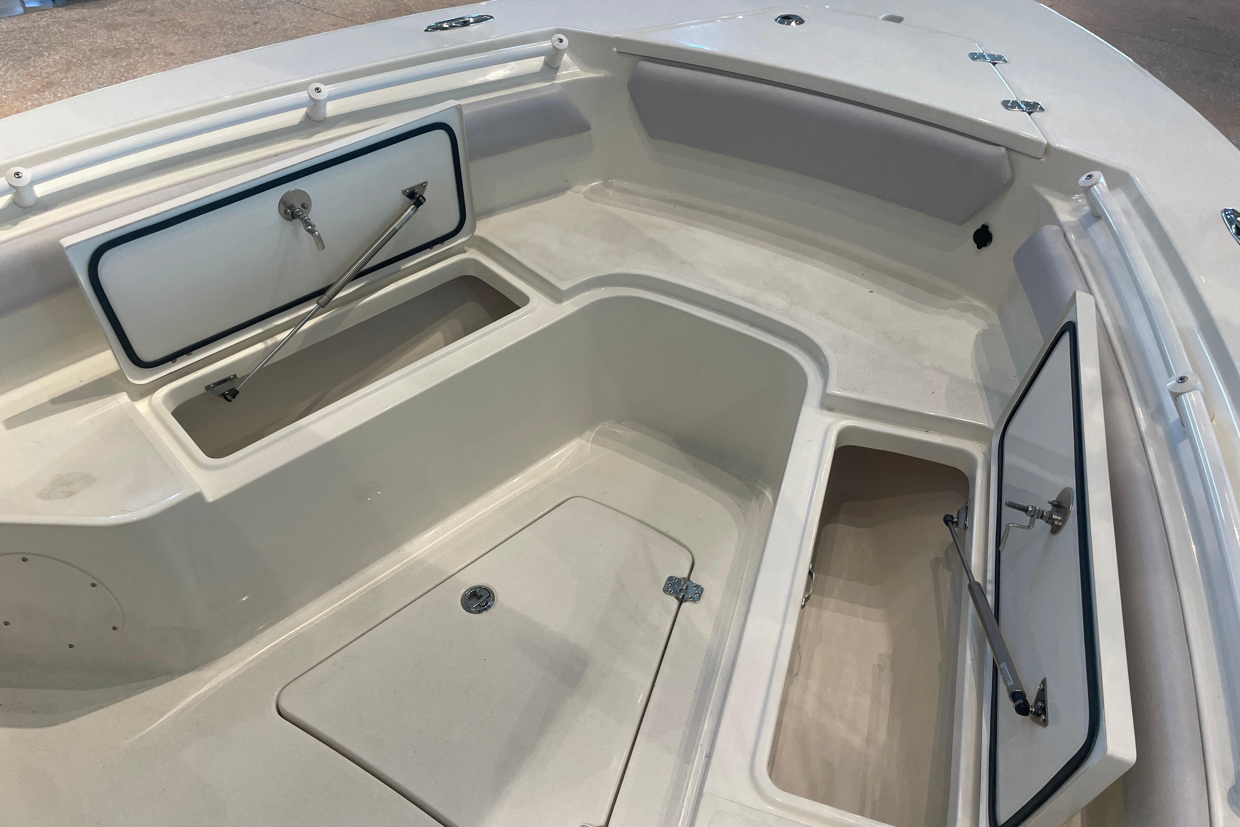 2026 Mako 226 Center Console boat with open storage compartments and sleek design.