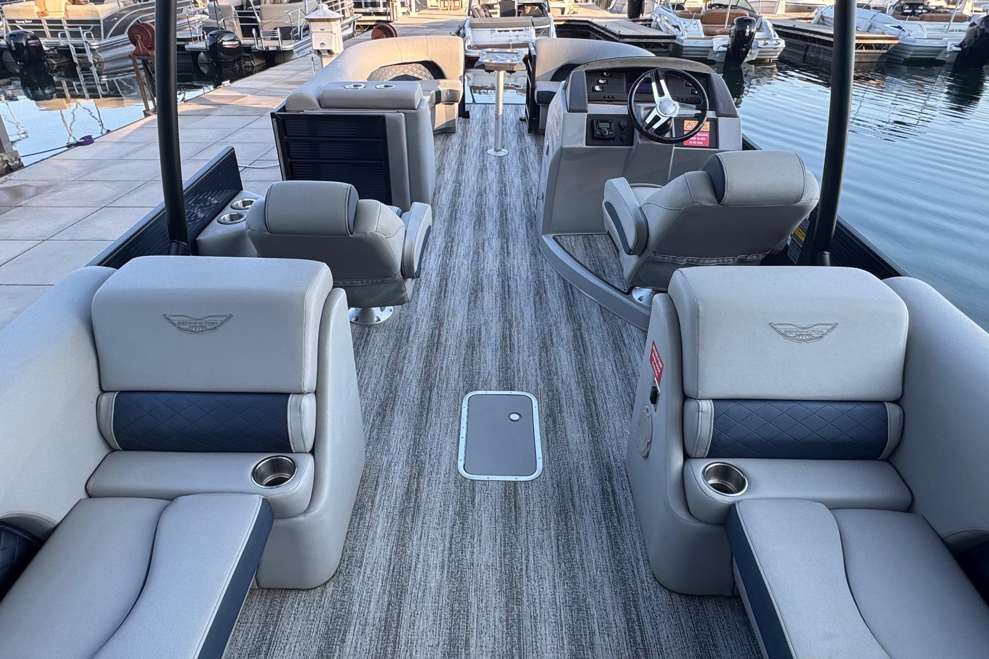 2025 Bennington 26 L Top Deck boat interior with luxurious seating and modern steering console.