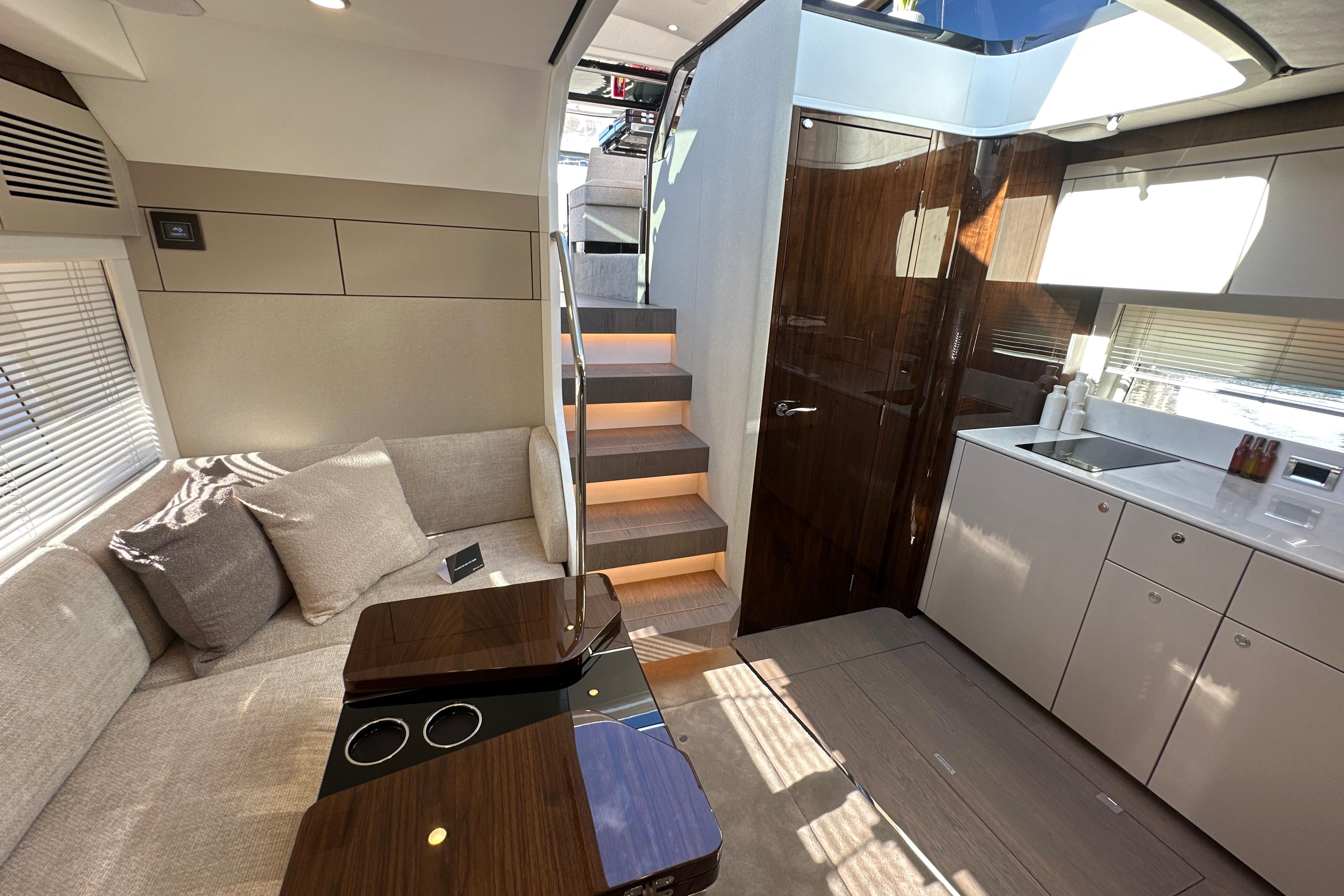 Luxurious interior of 2026 Fairline Targa 47 GT yacht with modern kitchen and seating area.