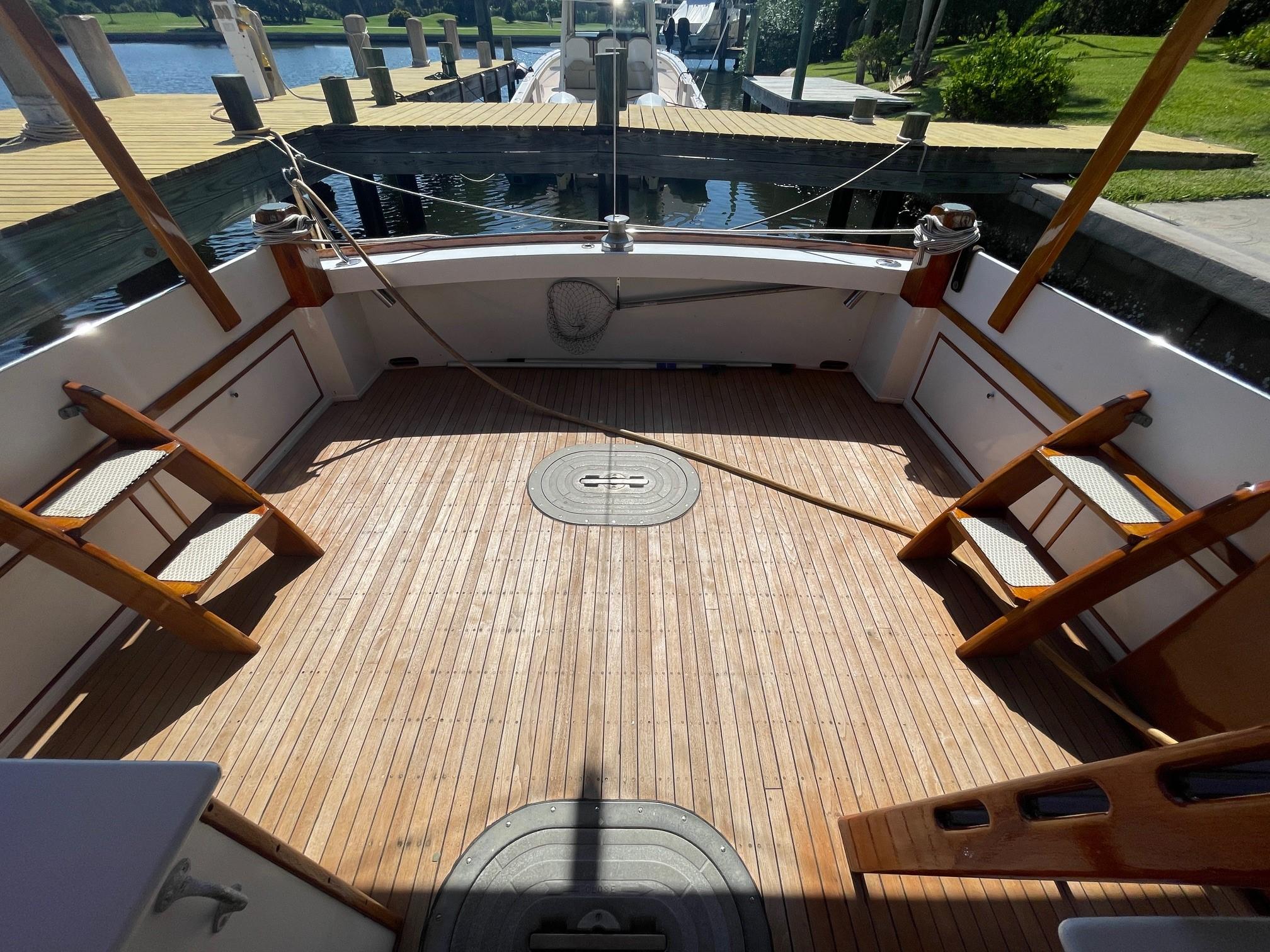 1979 Jarvis Newman Trawler with spacious wooden deck at a marina.