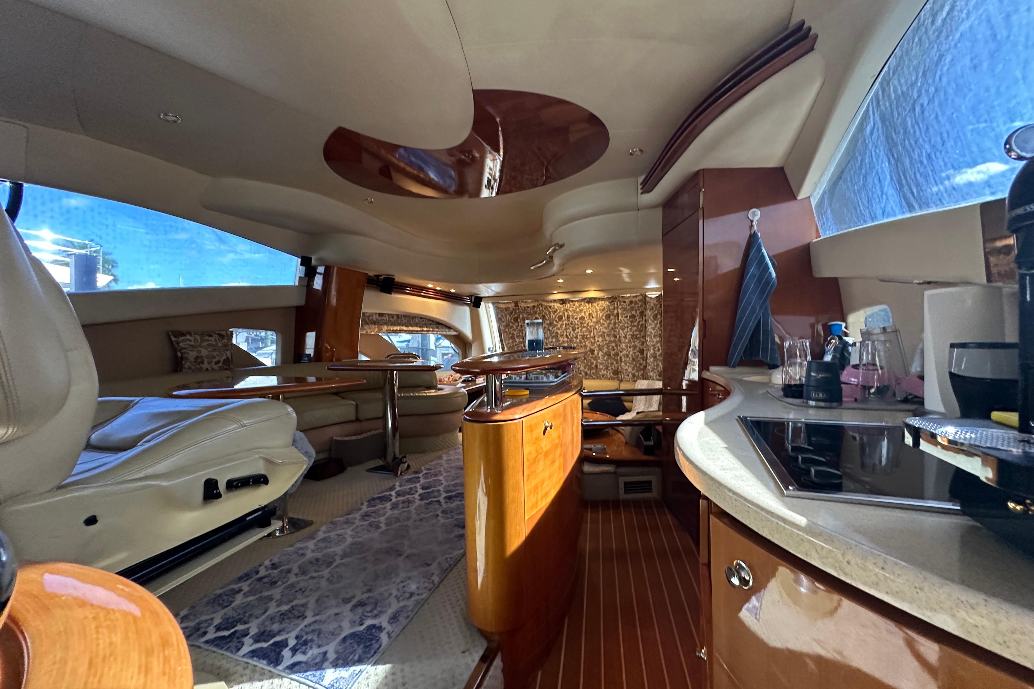Luxurious interior of a 2004 Azimut 55E yacht with modern amenities and elegant design.