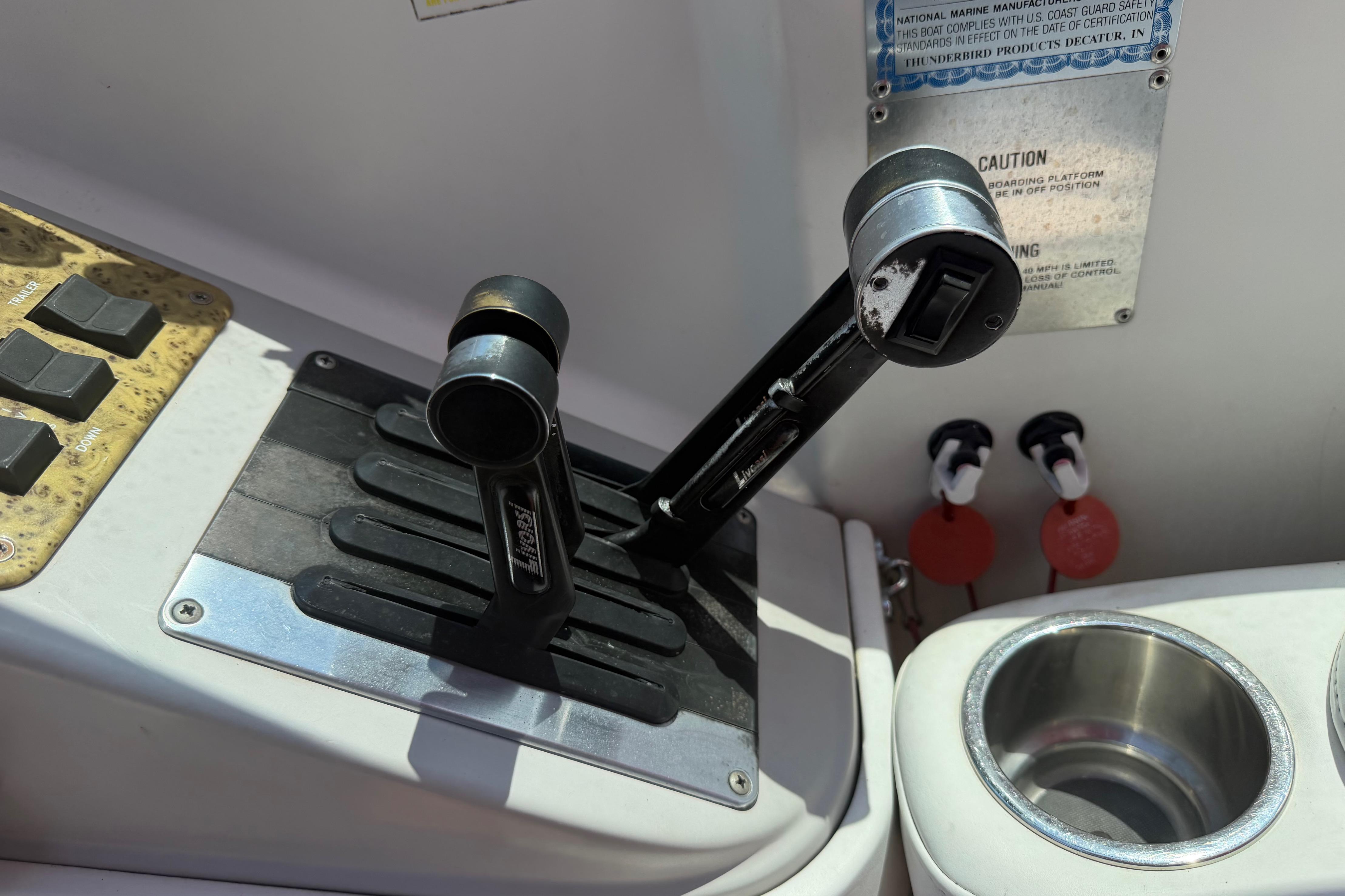 Throttle controls on a 2006 Formula 330 Sun Sport boat dashboard.