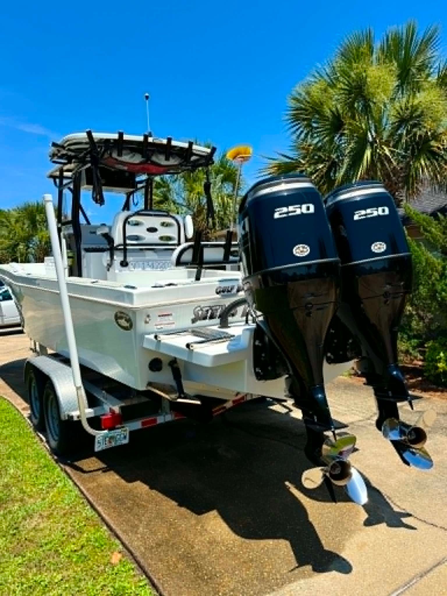 2023 Dusky 278 XFT boat with twin 250 HP engines on trailer.